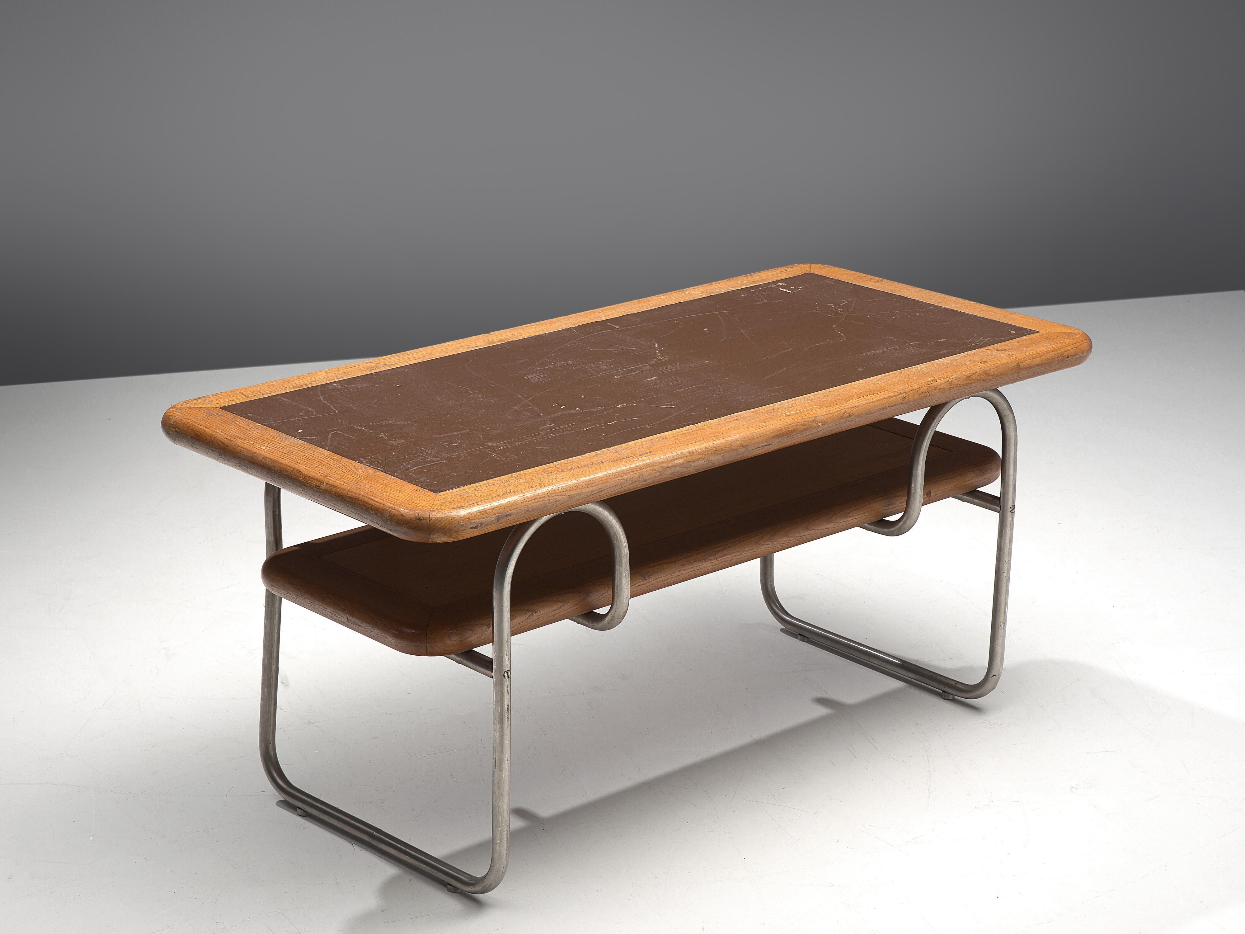 Coffee table, oak, metal, Europe, 1970s. 

Modest coffee table in oak. The rounded corners and outlines of this piece of furniture is striking. The table top contains a brown lacquered center. The outer edges show the natural color of the oak. A