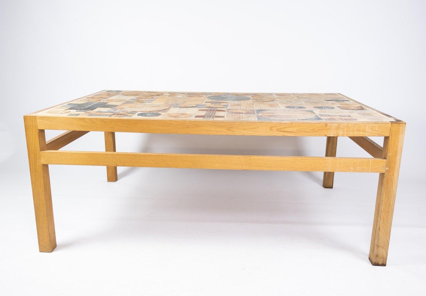 Coffee table in oak and with different tiles, designed by Tue Poulsen from the 1970s. The table is in great vintage condition.
  