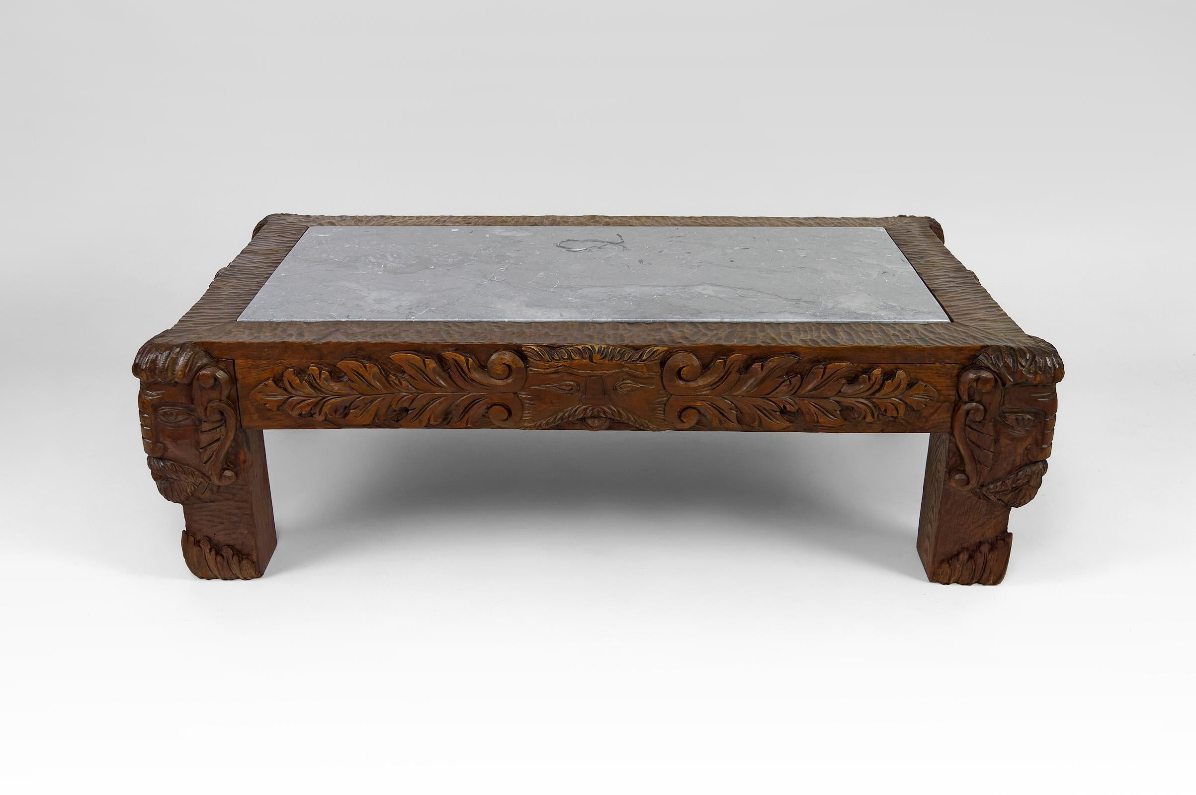 French Coffee table in oak carved with faun heads and marble top, France, Circa 1940 For Sale