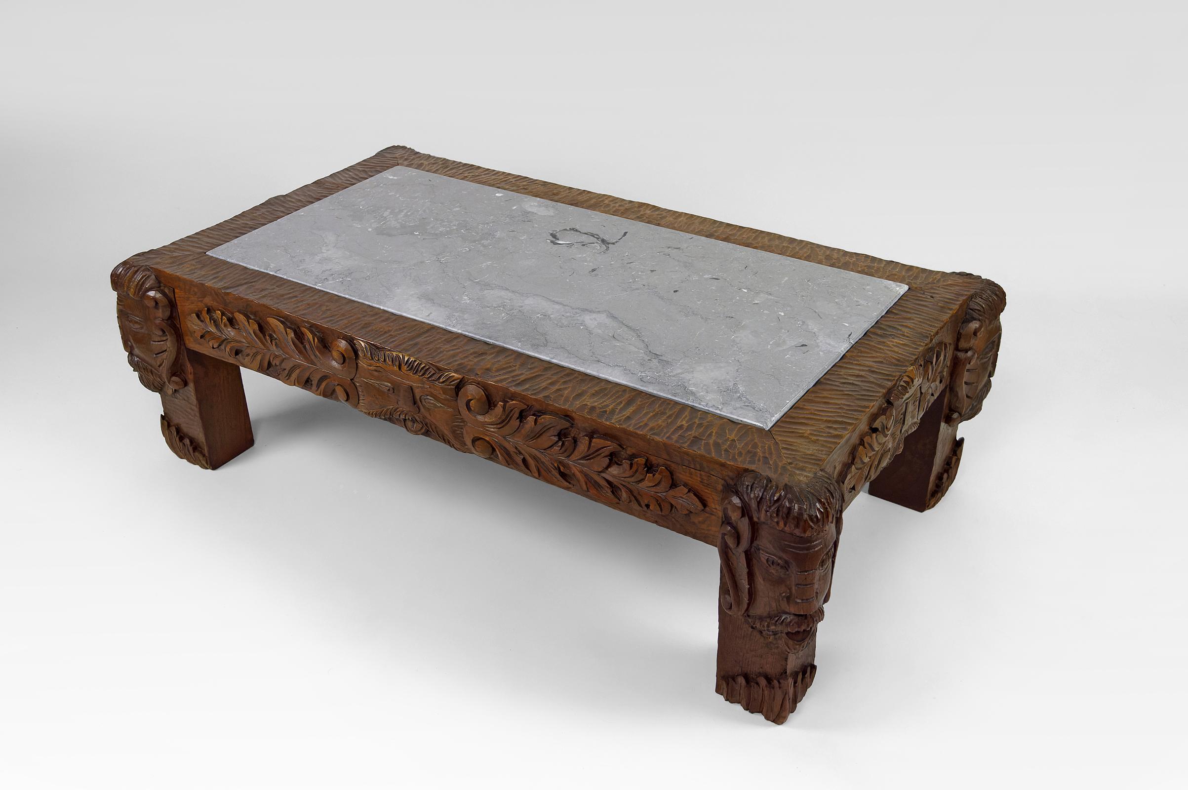 Carved Coffee table in oak carved with faun heads and marble top, France, Circa 1940 For Sale