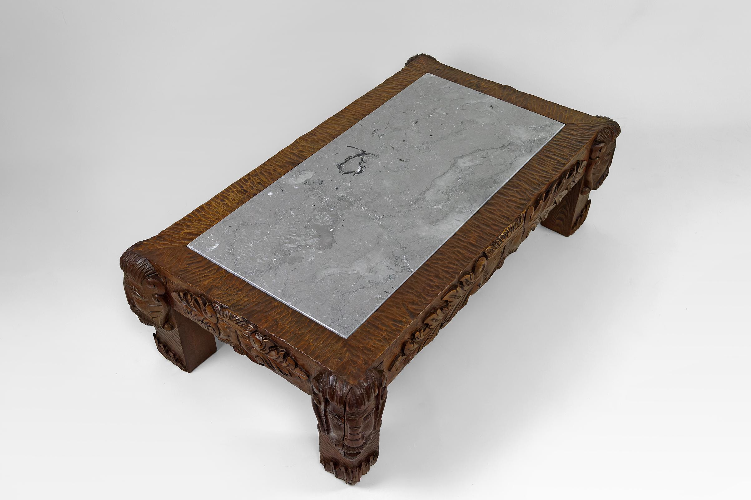 Marble Coffee table in oak carved with faun heads and marble top, France, Circa 1940 For Sale