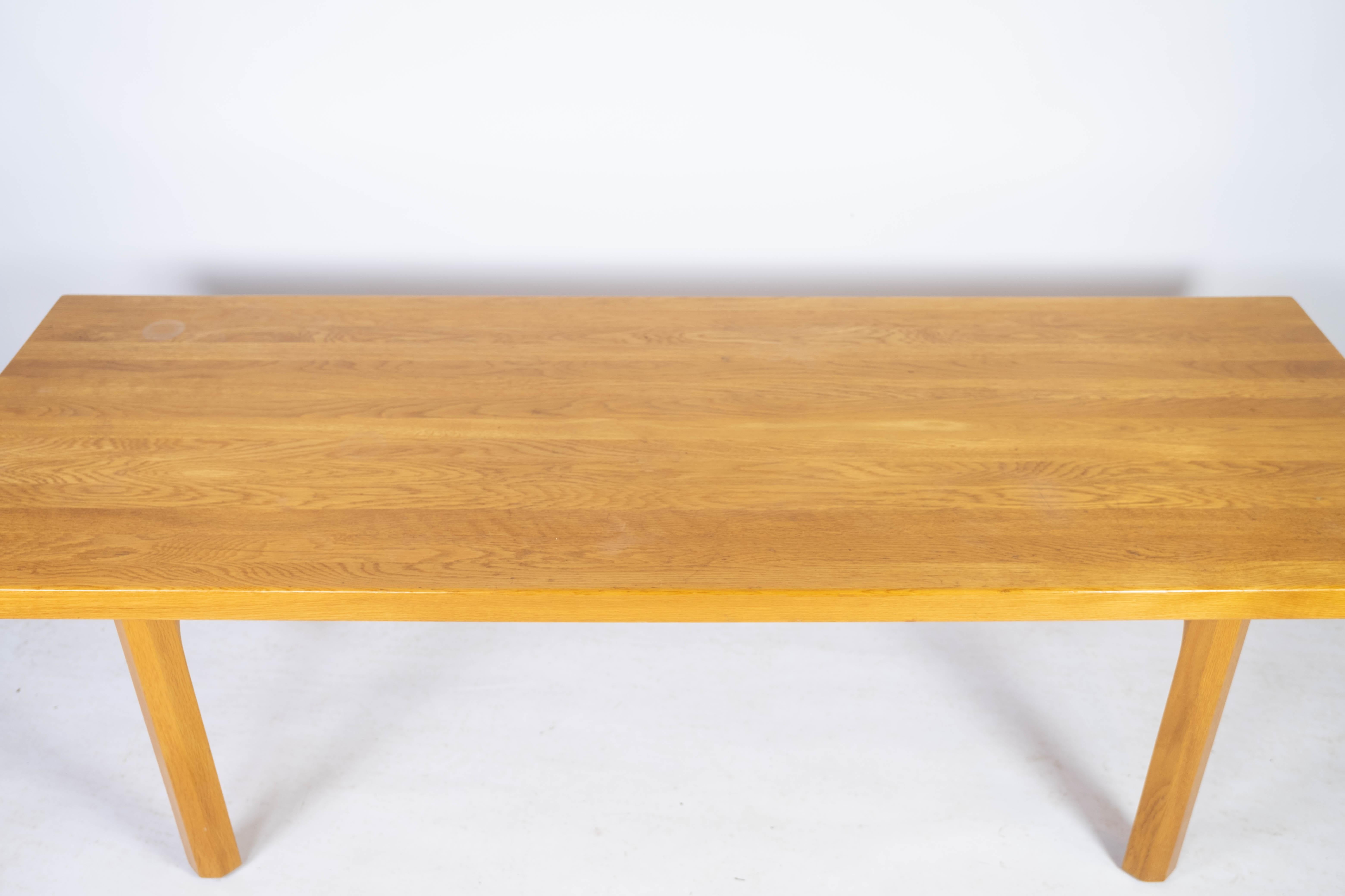 This coffee table from the 1960s is a good example of Danish design and aesthetics. Made from solid oak, it exudes a timeless elegance and durability that characterizes furniture from this era. The table's simple, clean lines and natural wood