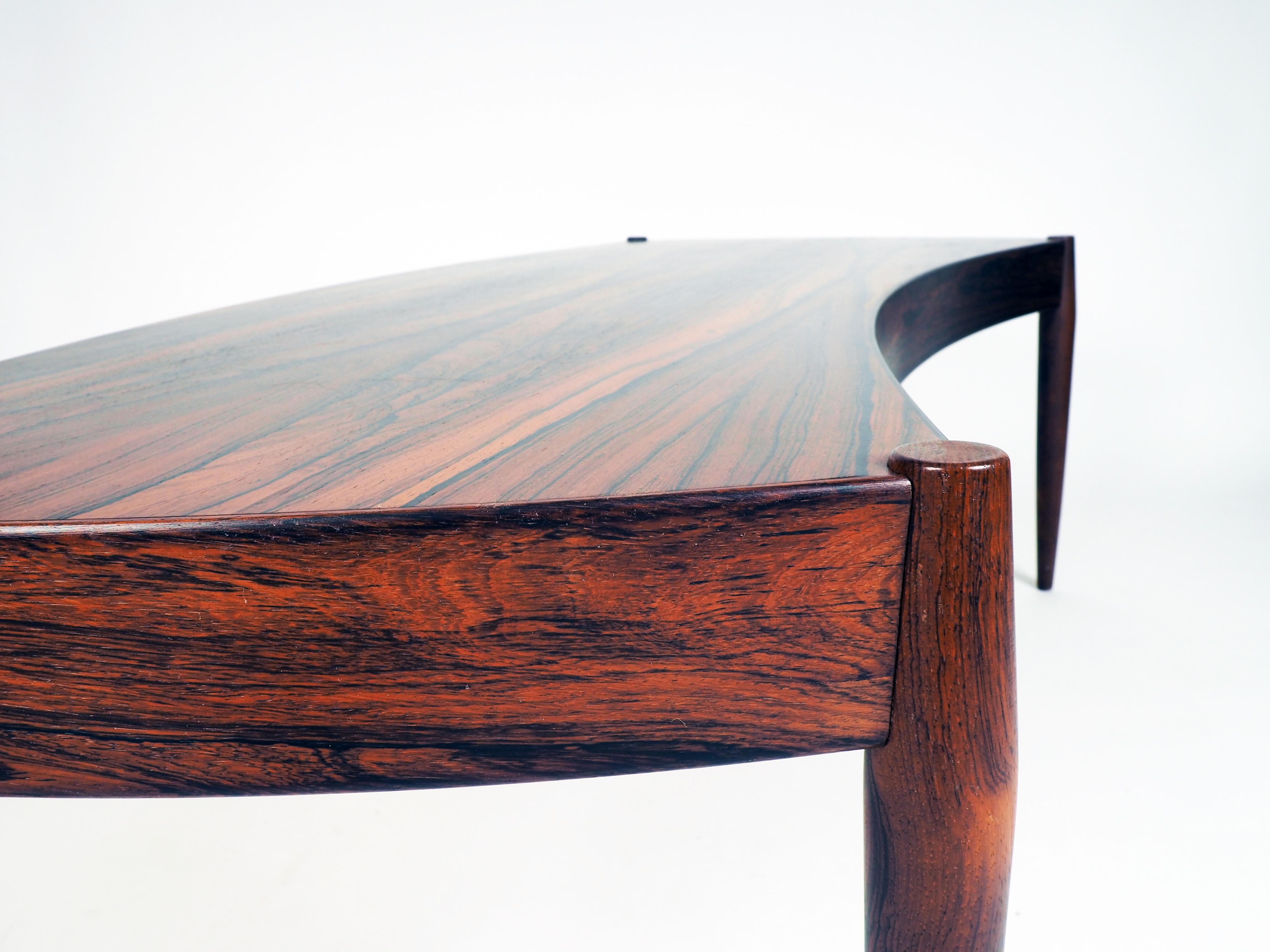 Coffee table in bent shape. Made in rosewood by Trensum, Sweden. The table was designed by the Danish architect Johannes Andersen.
