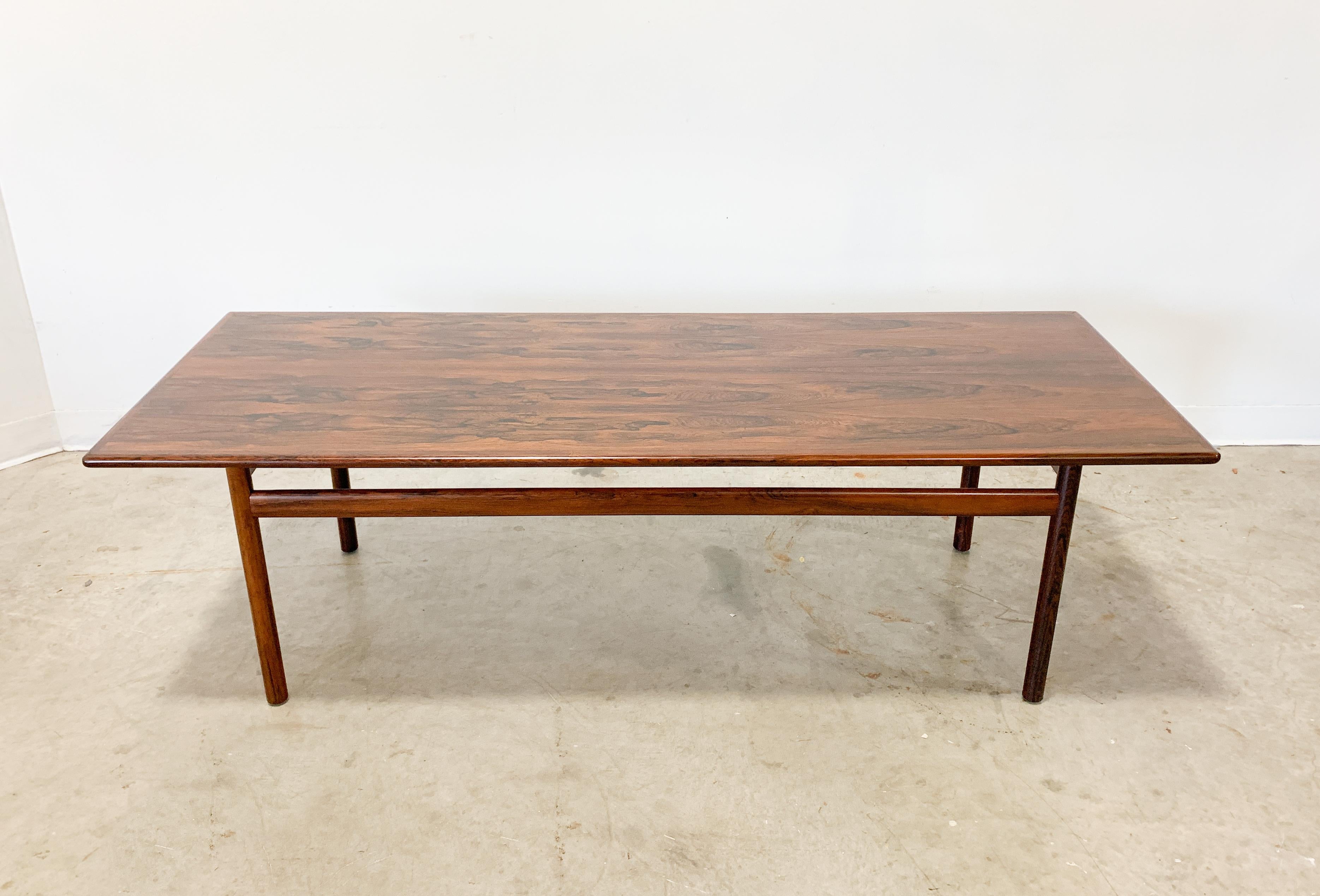 Beautiful rosewood table designed by Tobjorn Afdal for Vatne Mobler. Stunning grain across this Minimalist Scandinavian coffee table. Solid rosewood legs. Excellent condition.

Dimensions 60 x 18 x 15 H.