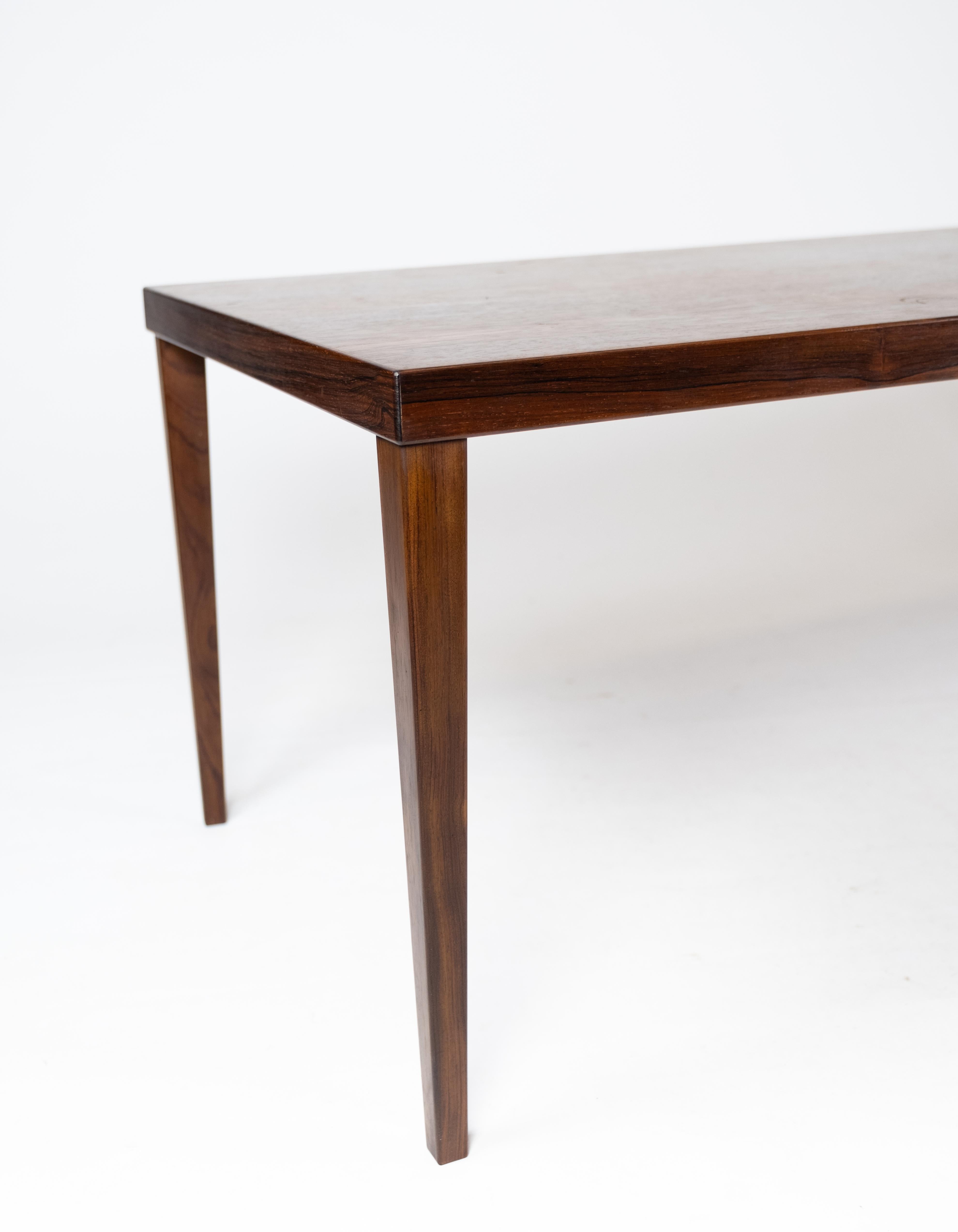 This rosewood coffee table epitomizes the elegance and craftsmanship of Danish design from the 1960s. Crafted with precision and attention to detail, it boasts a timeless appeal that adds sophistication to any living space.

The rich tones and grain