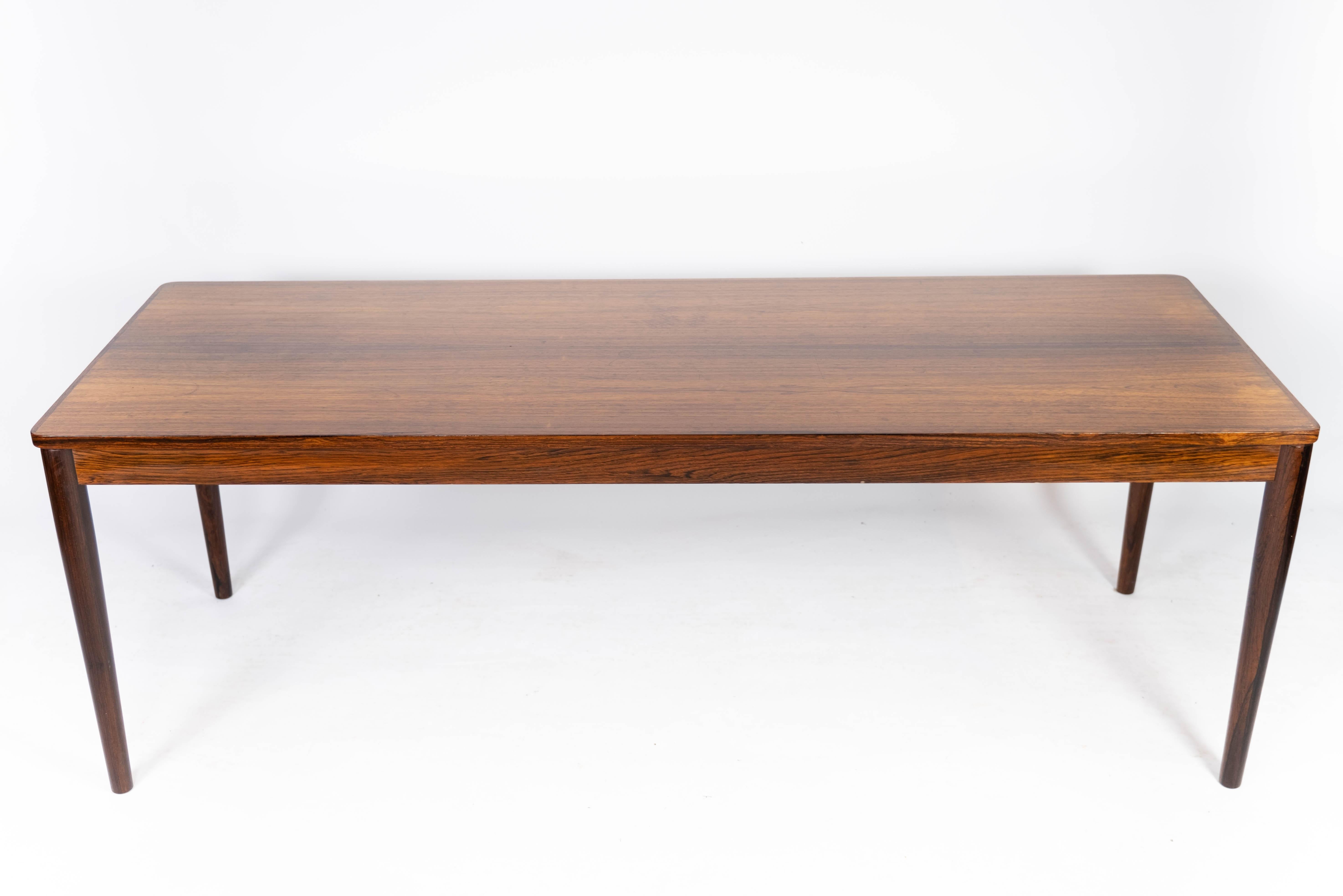 This rosewood coffee table from the 1960s exudes Danish design aesthetics at its finest. Made from rosewood, the table adds warmth and character to any room. With its simple and timeless design, it fits perfectly into both modern and classic