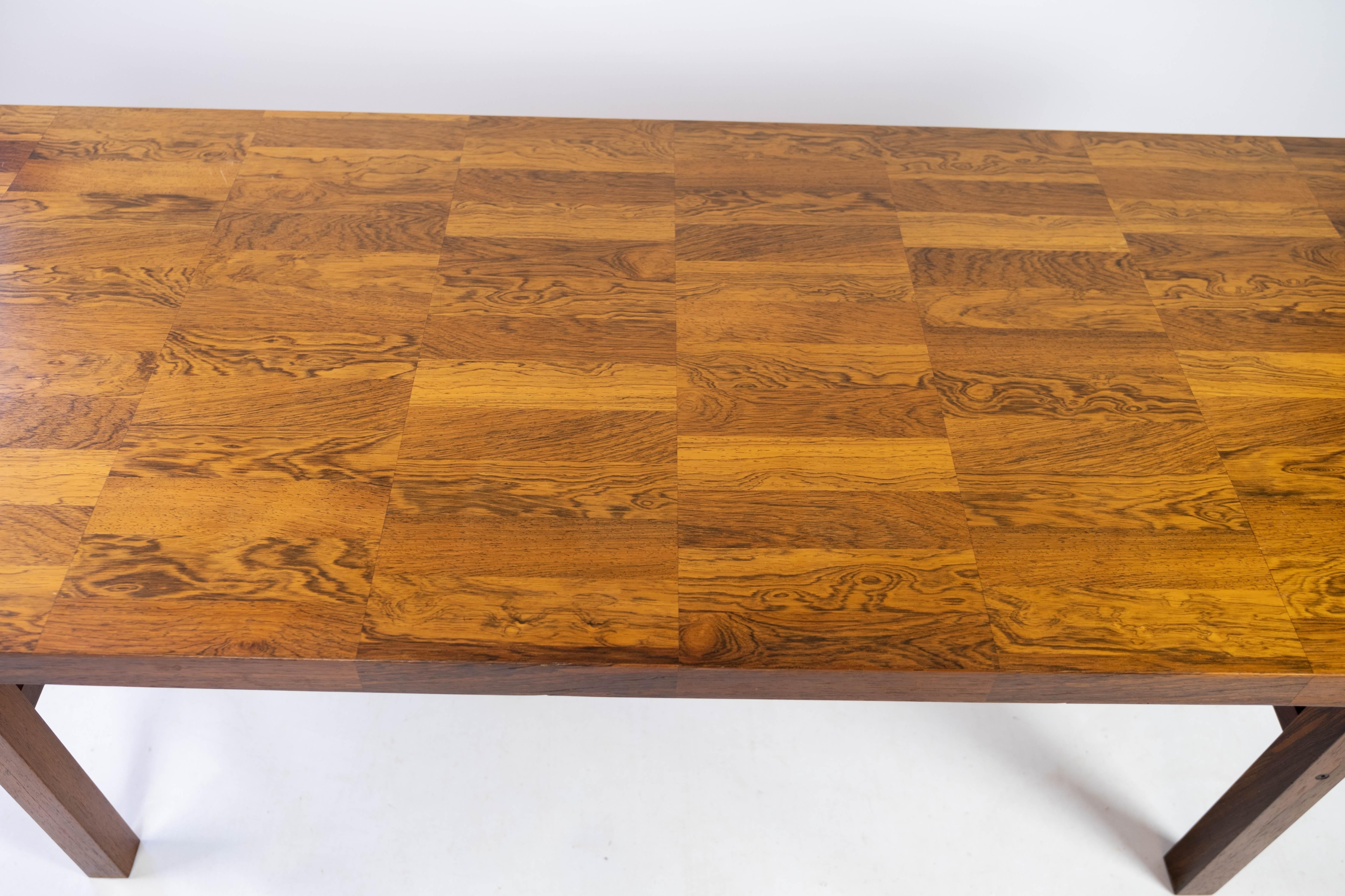This rosewood coffee table epitomizes the elegance and craftsmanship of Danish design from the 1960s. Crafted with precision and attention to detail, it boasts a timeless appeal that adds sophistication to any living space.

The rich tones and grain