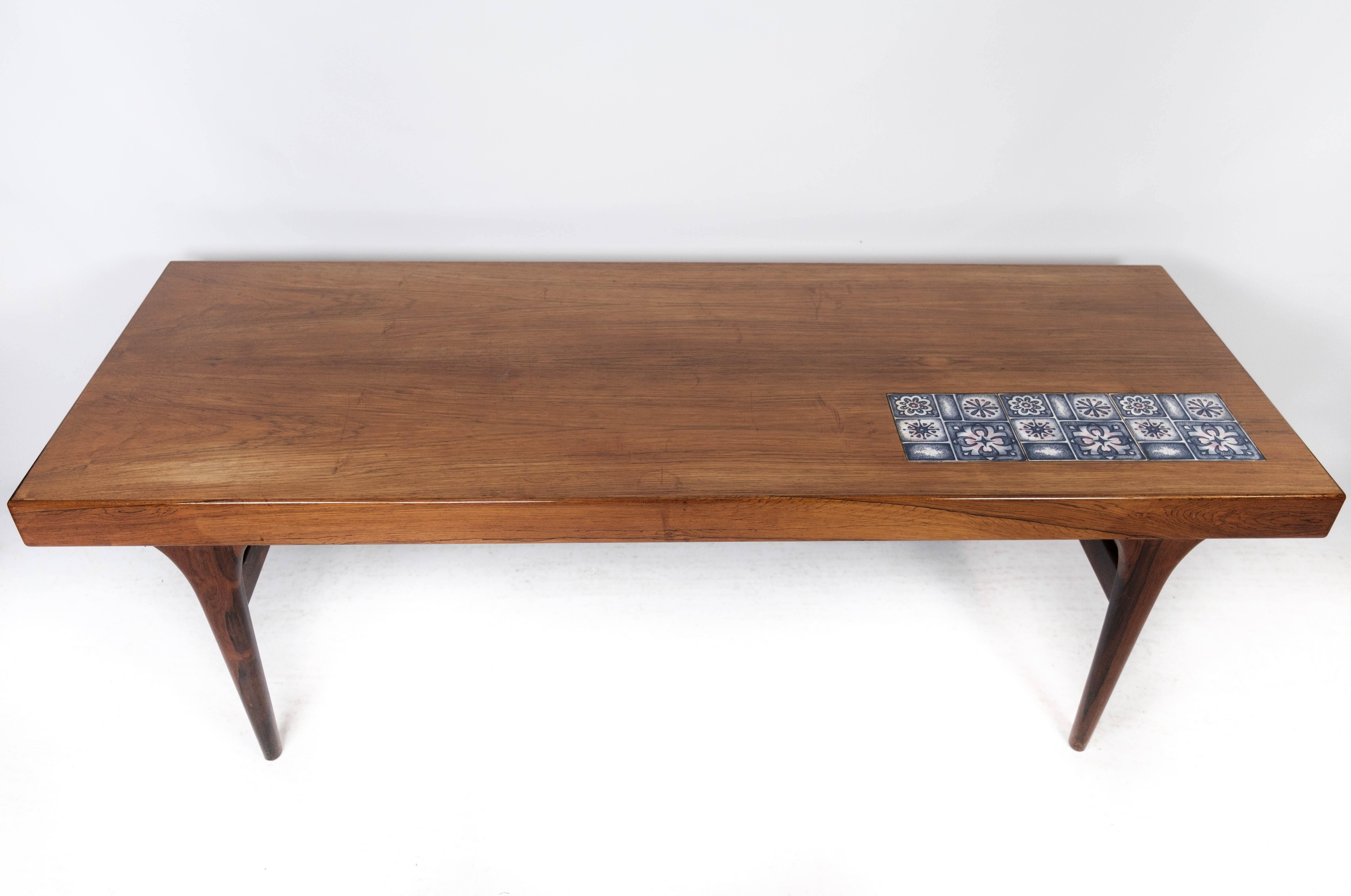 Coffee table in rosewood with blue tiles designed by Johannes Andersen and manufactured by Silkeborg Furniture in the 1960s. The table is in great vintage condition.