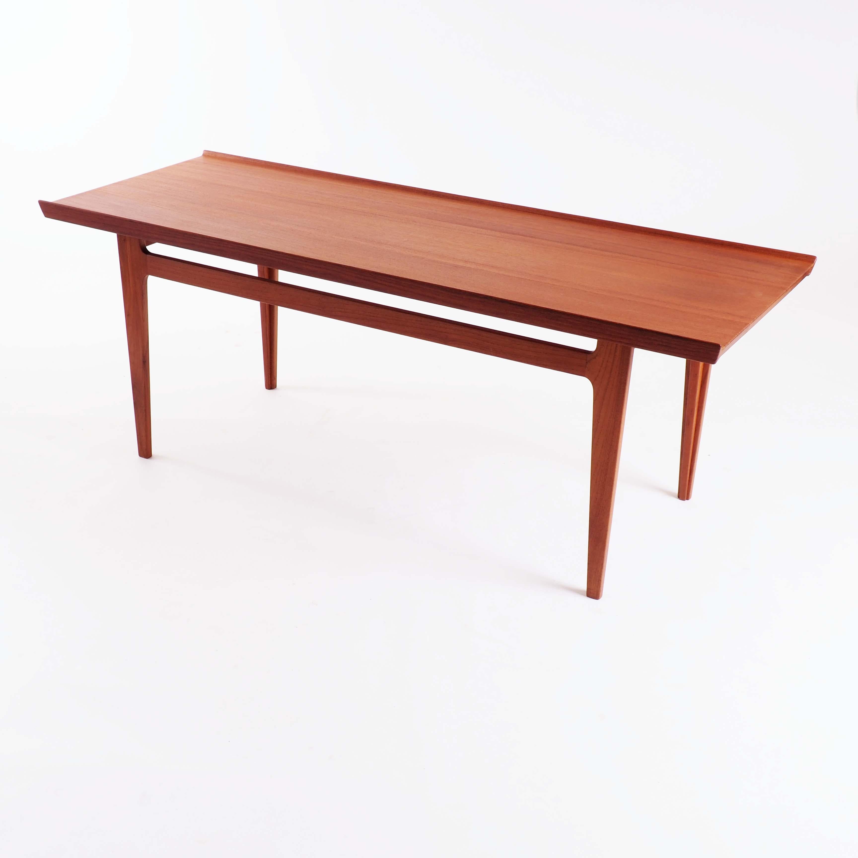 This coffee table in solid teak was designed by Finn Juhl for the Danish firm France & Son in 1959. A smaller version of this design is represented in Finn Juhls own house, now a museum.
 