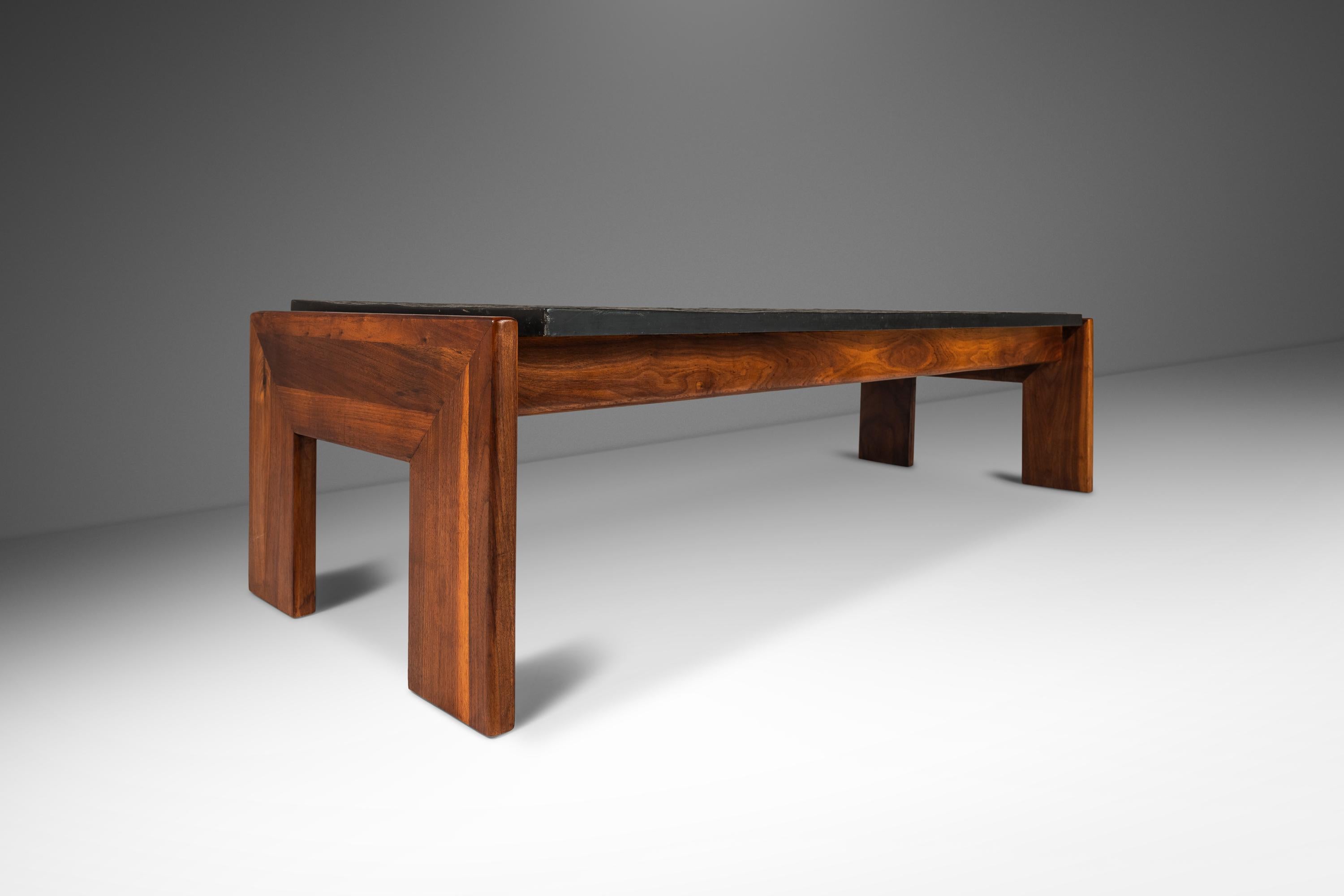 Introducing a rare and iconic slate-topped coffee table designed by the influential Adrian Pearsall for Craft Associates. Audacious in it's scope, shape and materials used this monolithic table is a true American masterpiece. With it's naturally