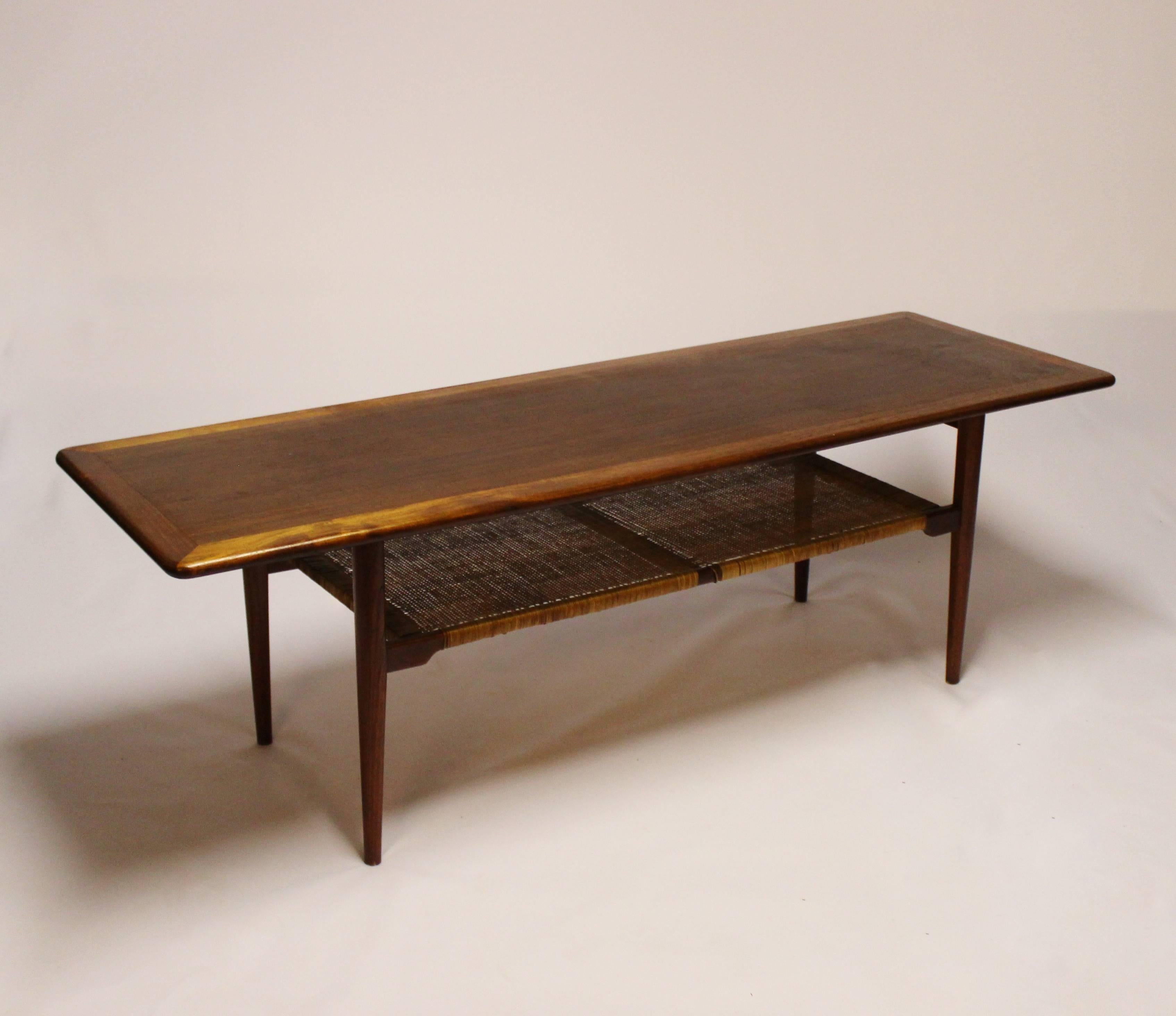 Coffee table in teak with paper cord shelf of Danish design from the 1960s. The table is in great vintage condition.