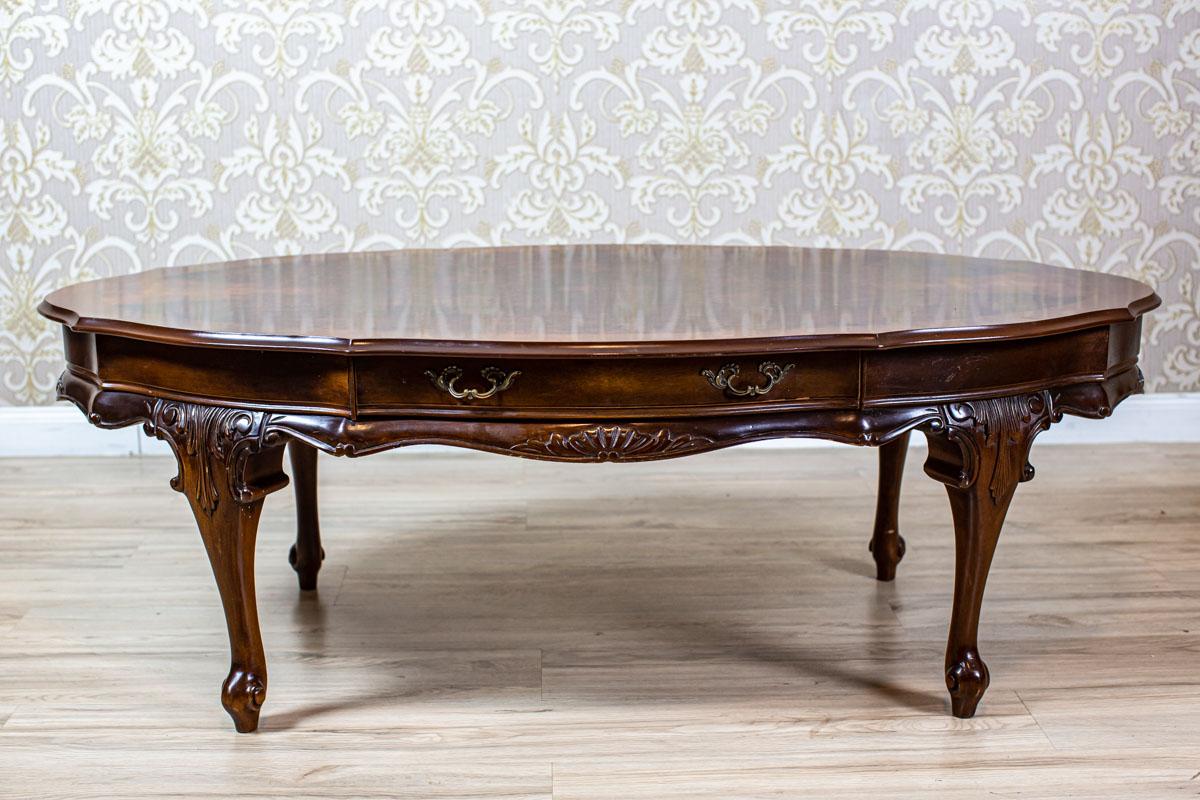 Oval Coffee Table in the Louis Philippe Type, Circa 1980s-1990s

We present you a low, oval table that is intended to be used with a sofa.
This piece of furniture is modern, stylized as Louis Philippe furniture.
The table is placed on bent legs.