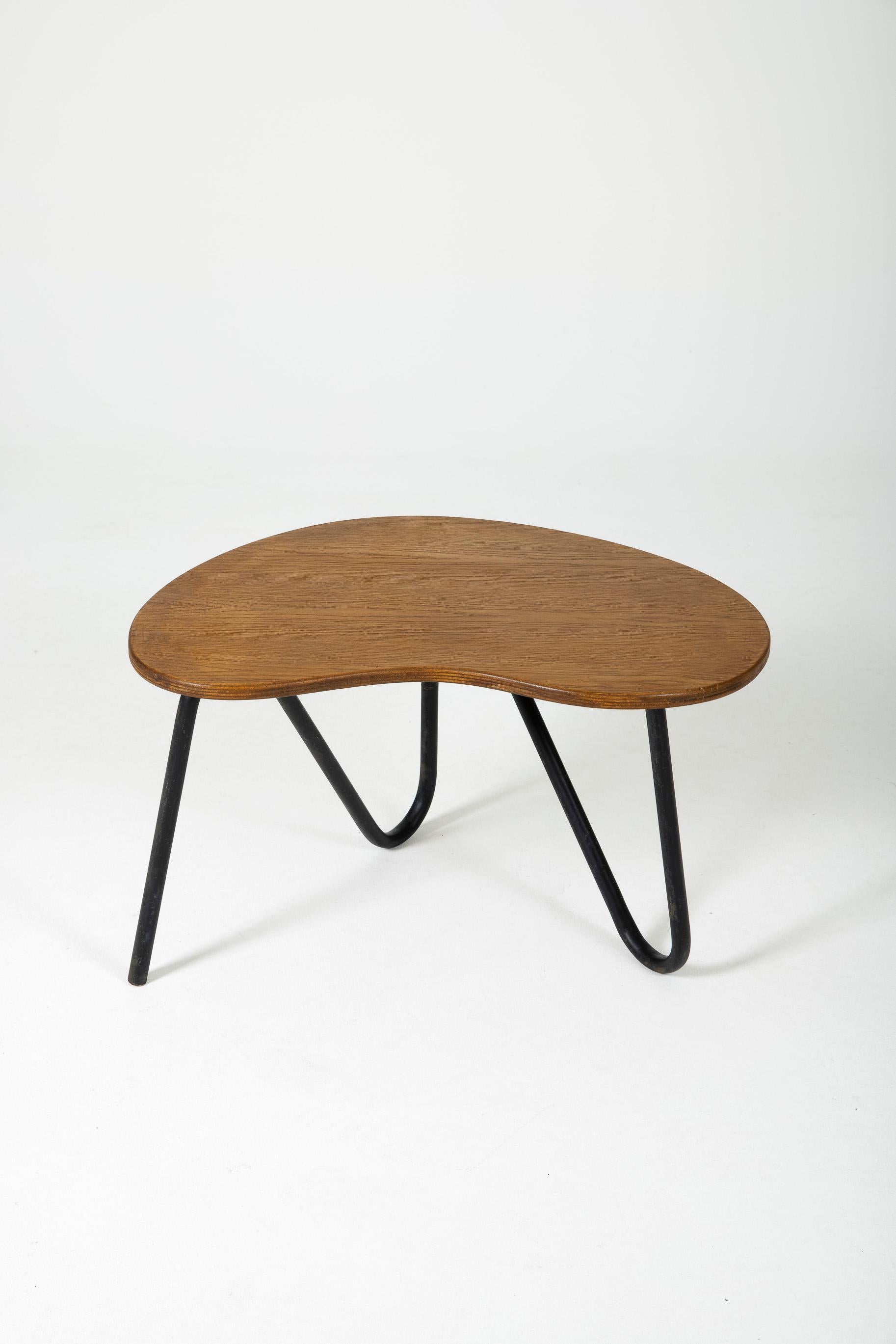 Coffee table in wood and metal, model 'Perfacto' by designer Pierre Guariche (1926–1995) in the 1950s (1957). Wooden tabletop, free-form black lacquered metal base. Pierre Guariche (1926–1995) was a renowned French designer and architect, active in