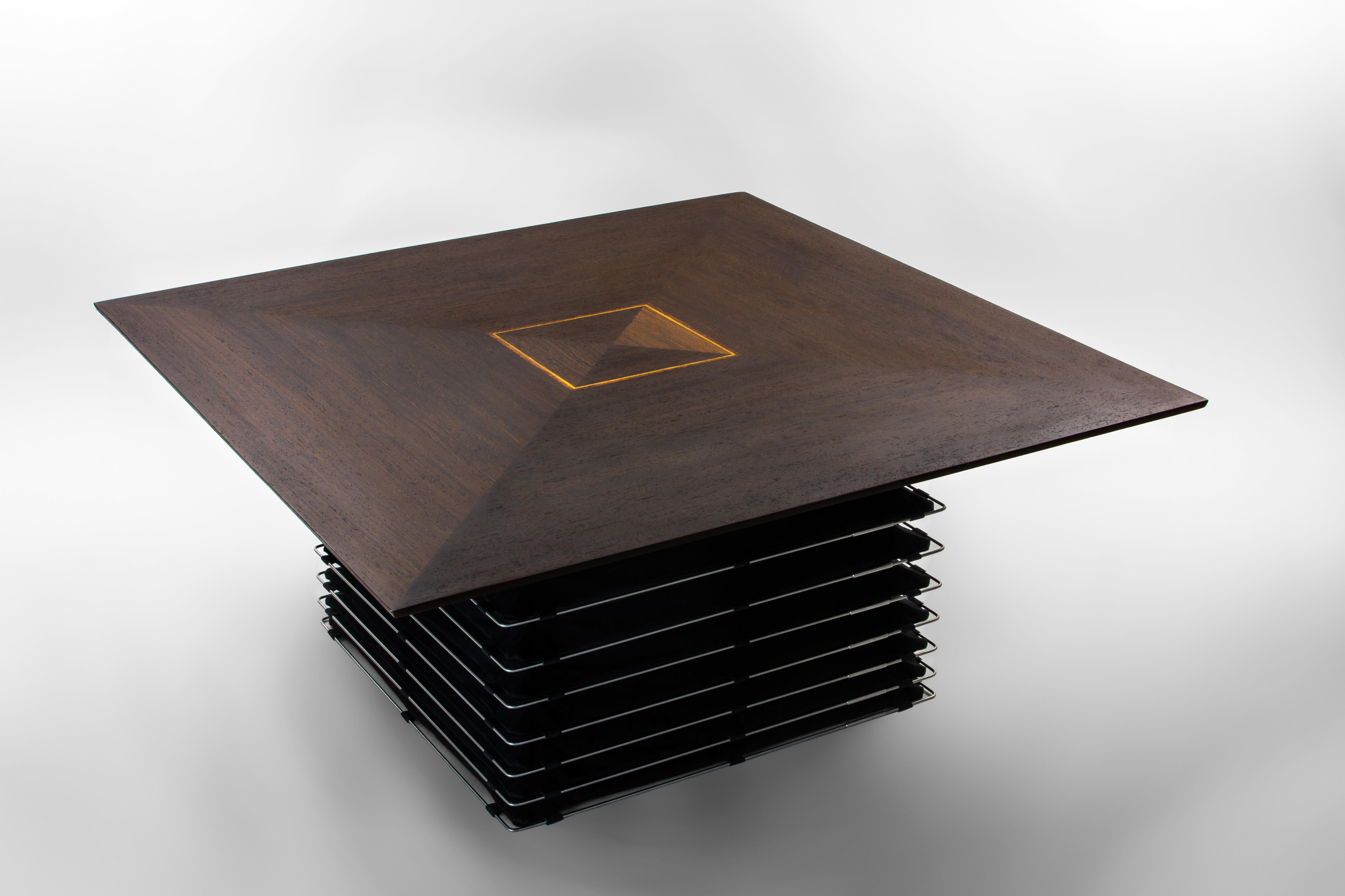 The coffee table from our Finish Collection is a striking and unique piece of furniture that boasts meticulous craftsmanship and design elements. The table's square top features a classic mosaic pattern, divided into four triangle sections, that