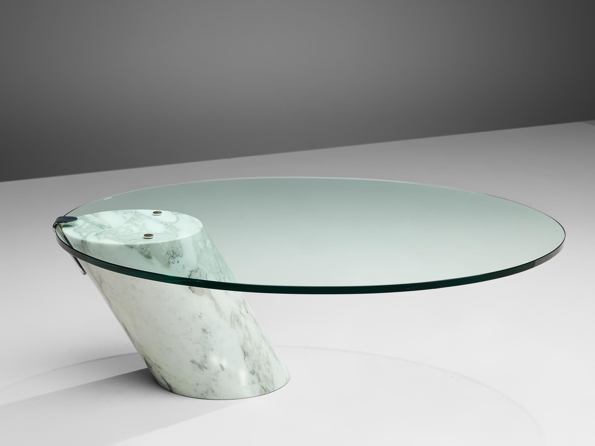Team Form AG for Ronald Schmitt, coffee table model 'K1000', marble and glass, Switzerland, circa 1974. 

This cocktail table is made of a solid Carrara marble base with a clear glass top. The oval top is attached to the skewed cylindrical base,