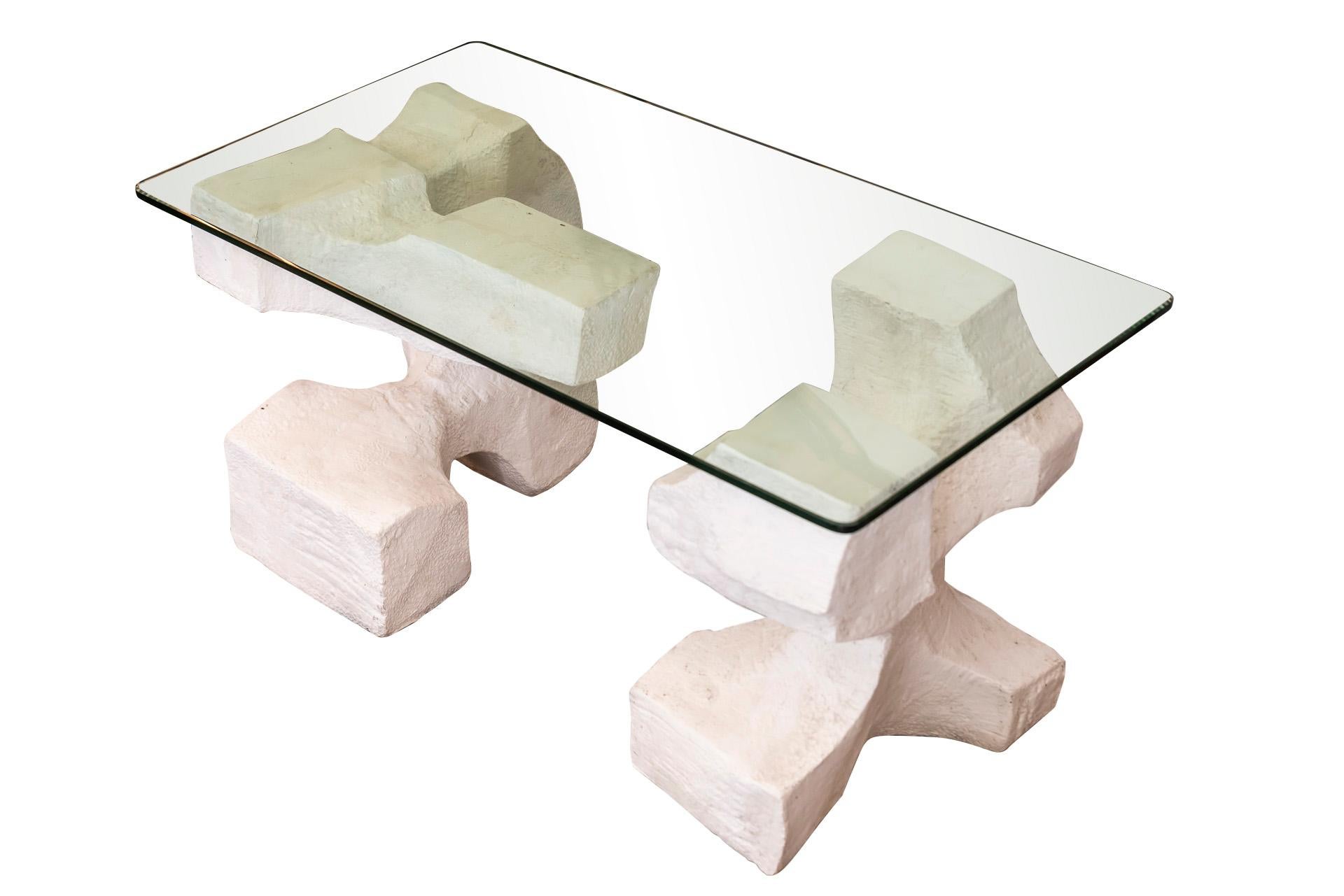 Coffee table made from two sculptures,
Glass tabletop and chipped stone, 
Cubic-shaped base,
France, circa 1970.

Measures: Width 90 cm, depth 48 cm, height 45 cm.