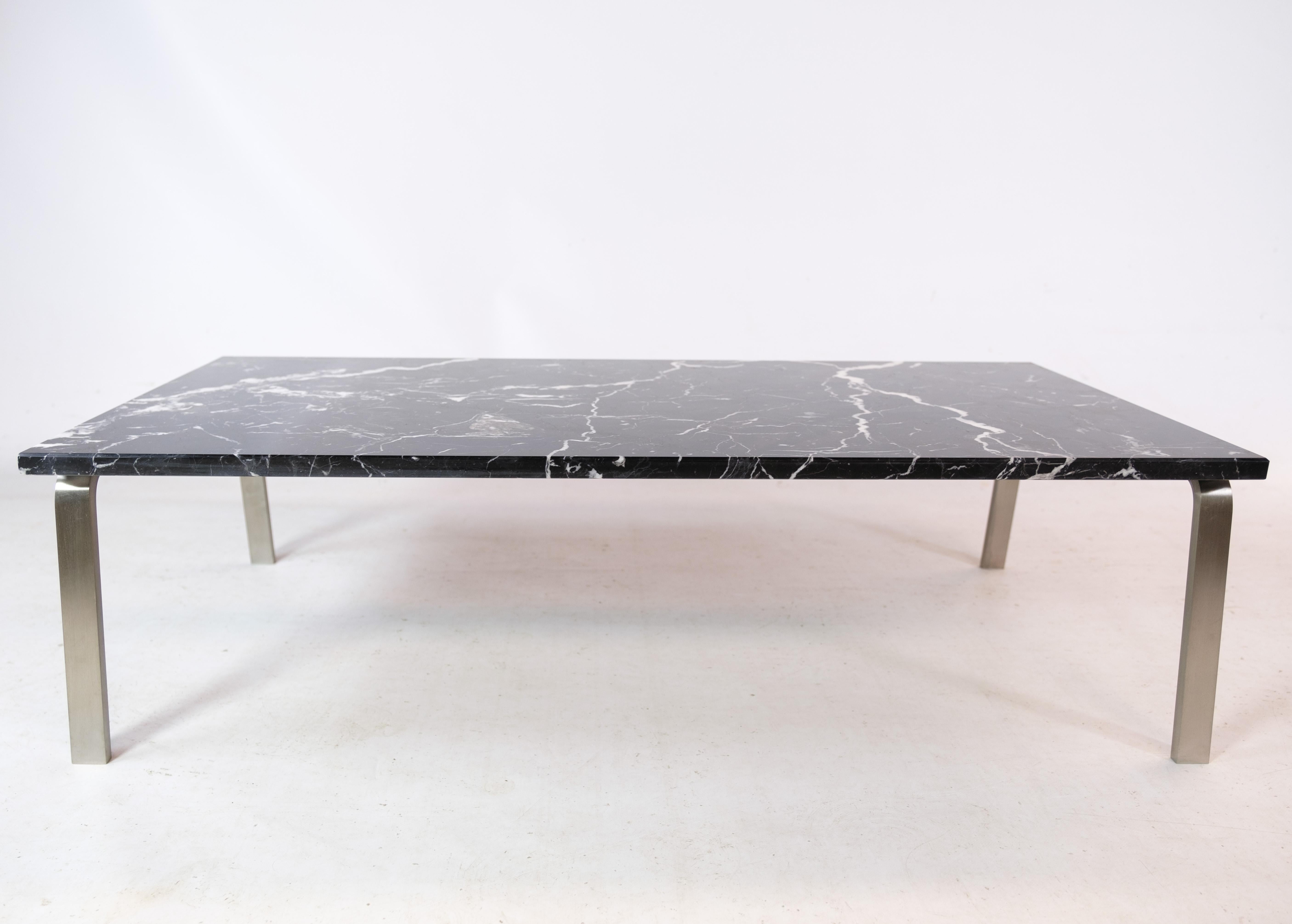 Coffee table by Norr11, featuring an aluminum frame and a luxurious Danish design marble top, crafted in the 2000s. This contemporary piece seamlessly blends modern aesthetics with timeless elegance. With its clean lines and premium materials, it