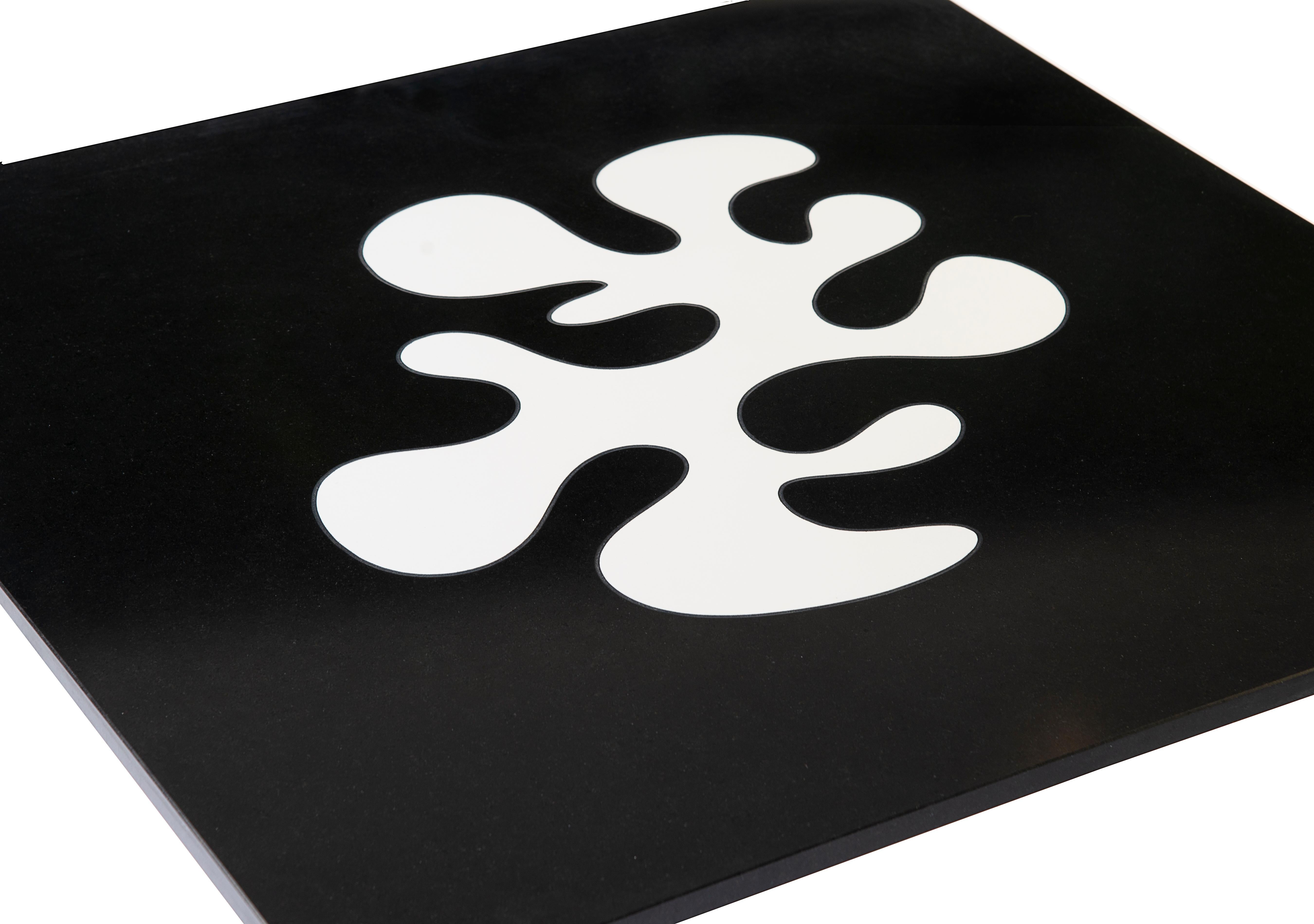 Grande table basse en granit noir de Whiting et marbre blanc reconstitué dans un motif inspiré de Matisse. La base est constituée de 4 supports solides en laiton brossé disposés de manière asymétrique.

Fabriqué à la main en France, près de