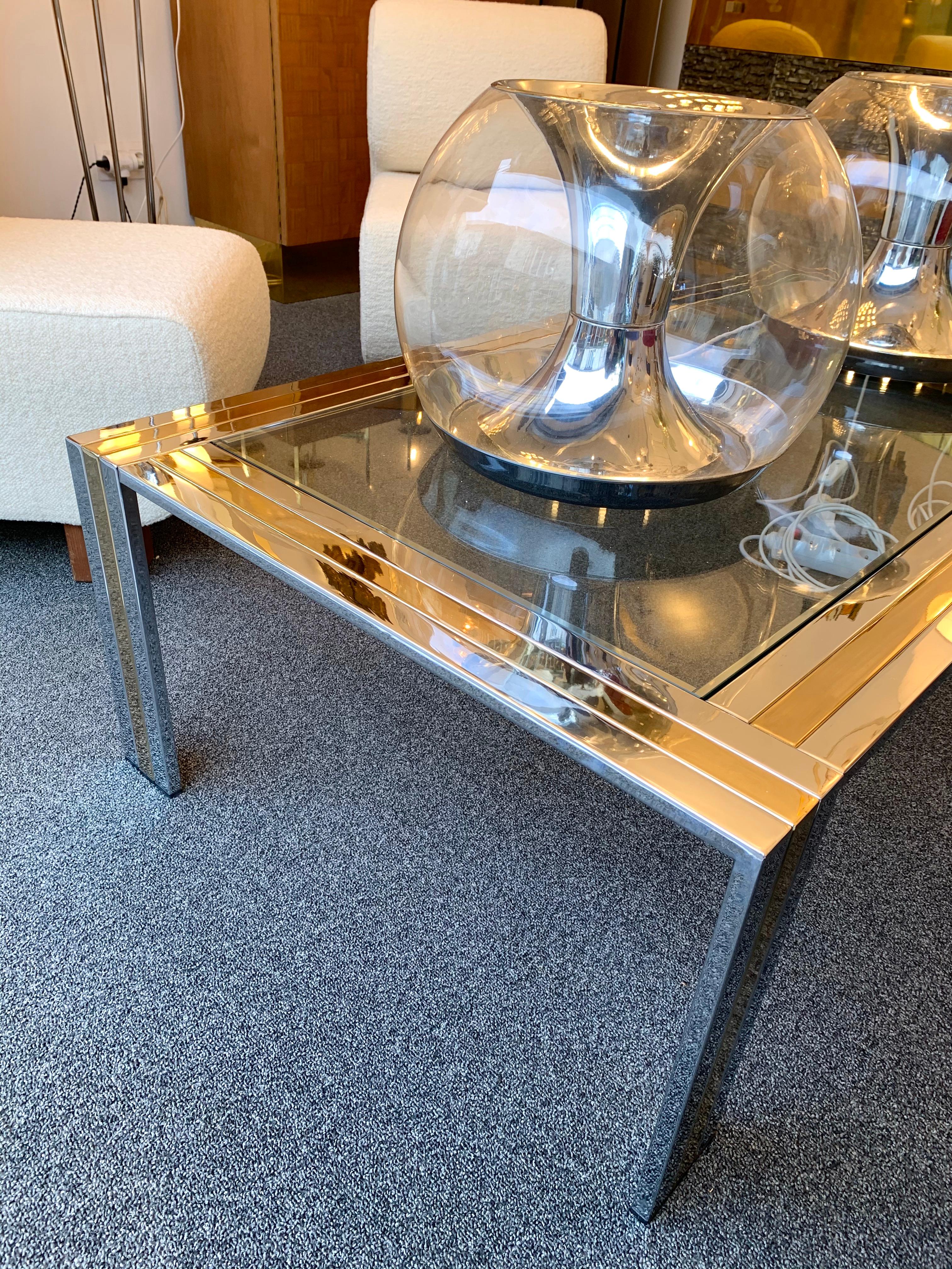 Metal chrome, brass and glass top coffee low cocktail table by Renato Zevi. Famous design like Romeo Rega, Willy Rizzo, Mario Sabot, Maison Jansen, Charles.
