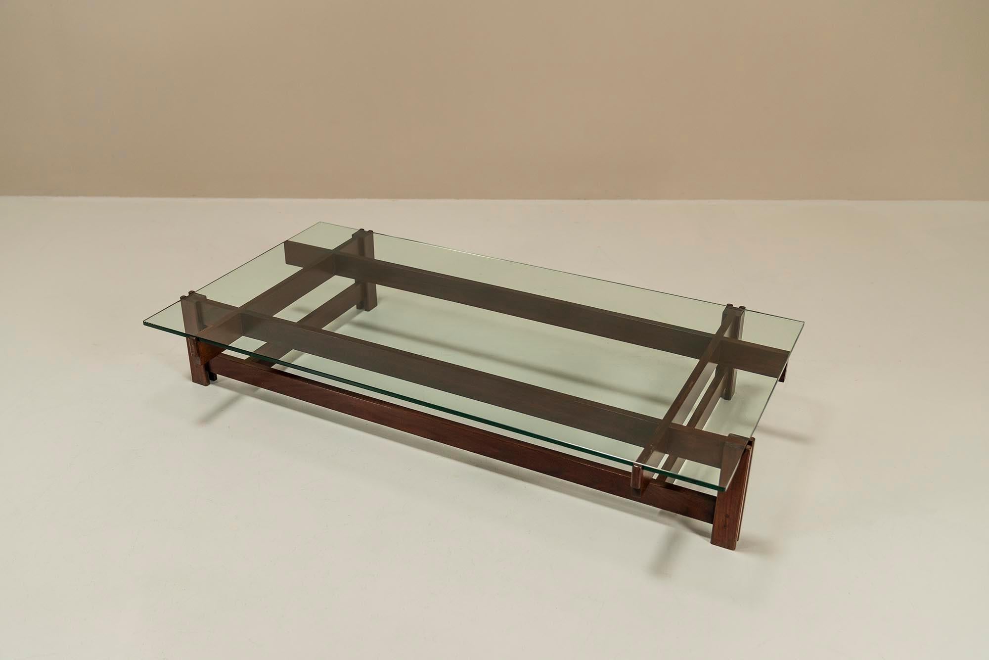 This beautiful timeless coffee table has an architectural character and can be used effortlessly in a variety of interior styles. It was designed in 1962 by the famous Italian architect Ico Parisi.The solid rosewood frame is ingeniously constructed