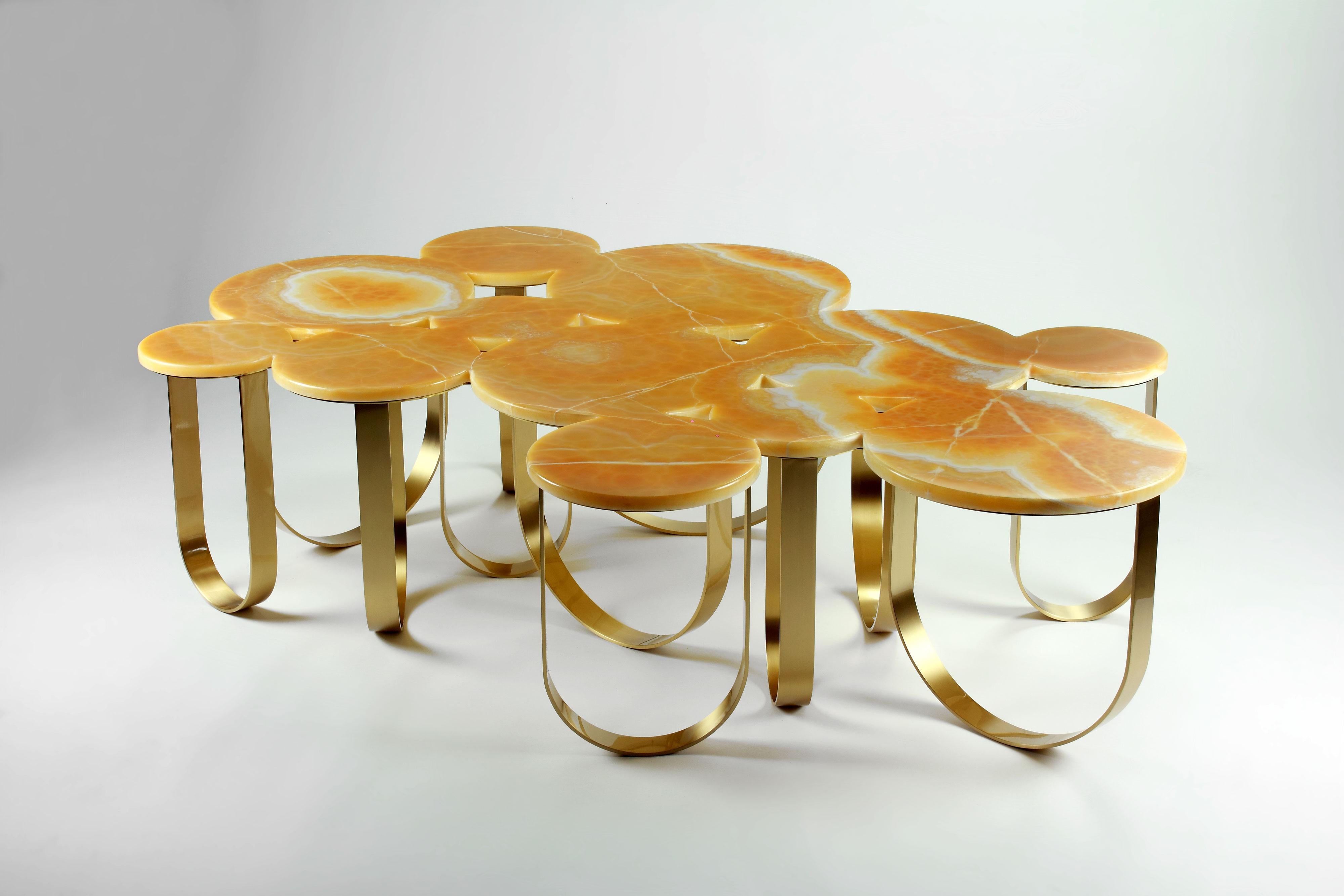 The 'Cloud' is a spectacular coffee table with structure in brushed brass and top in orange onyx. The brushed finishing of the brass creates interesting reflections of light. 

This artwork is available as a one piece and three pieces coffee table.
