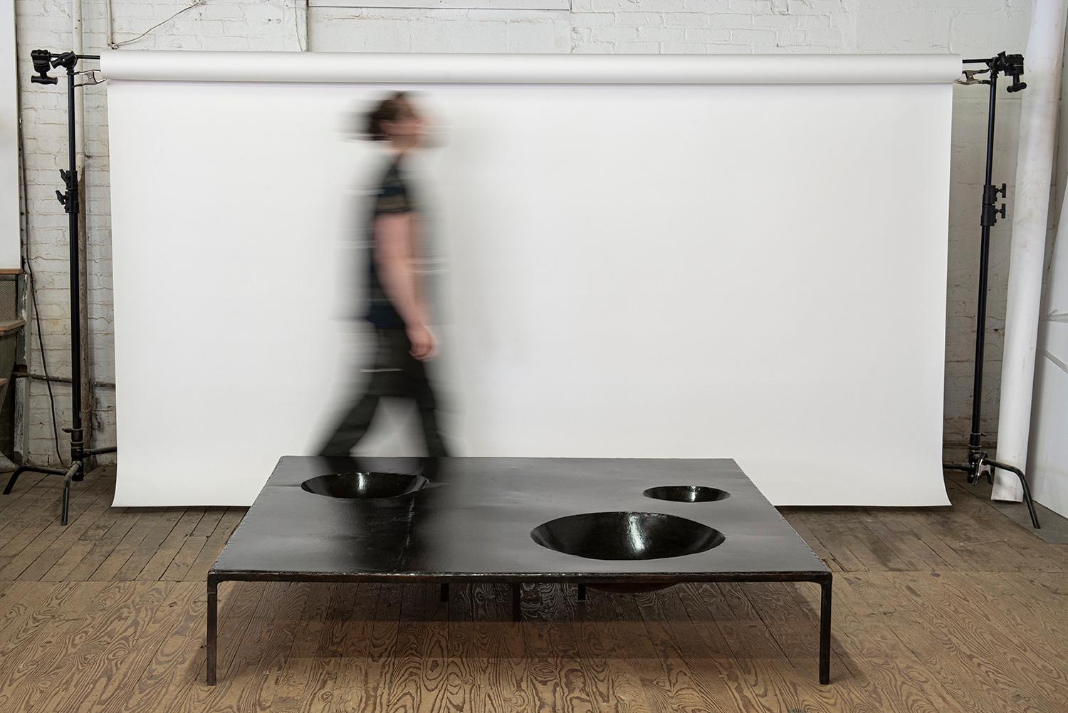 ***instock / archived one of one***
Table no. 11 - coffee table
Materials: rich patina, hand hewn quality, hand hammered steel bowls
J.M. Szymanski
d. 2018
 
Handmade entirely out of blackened and waxed steel, this table features geometric