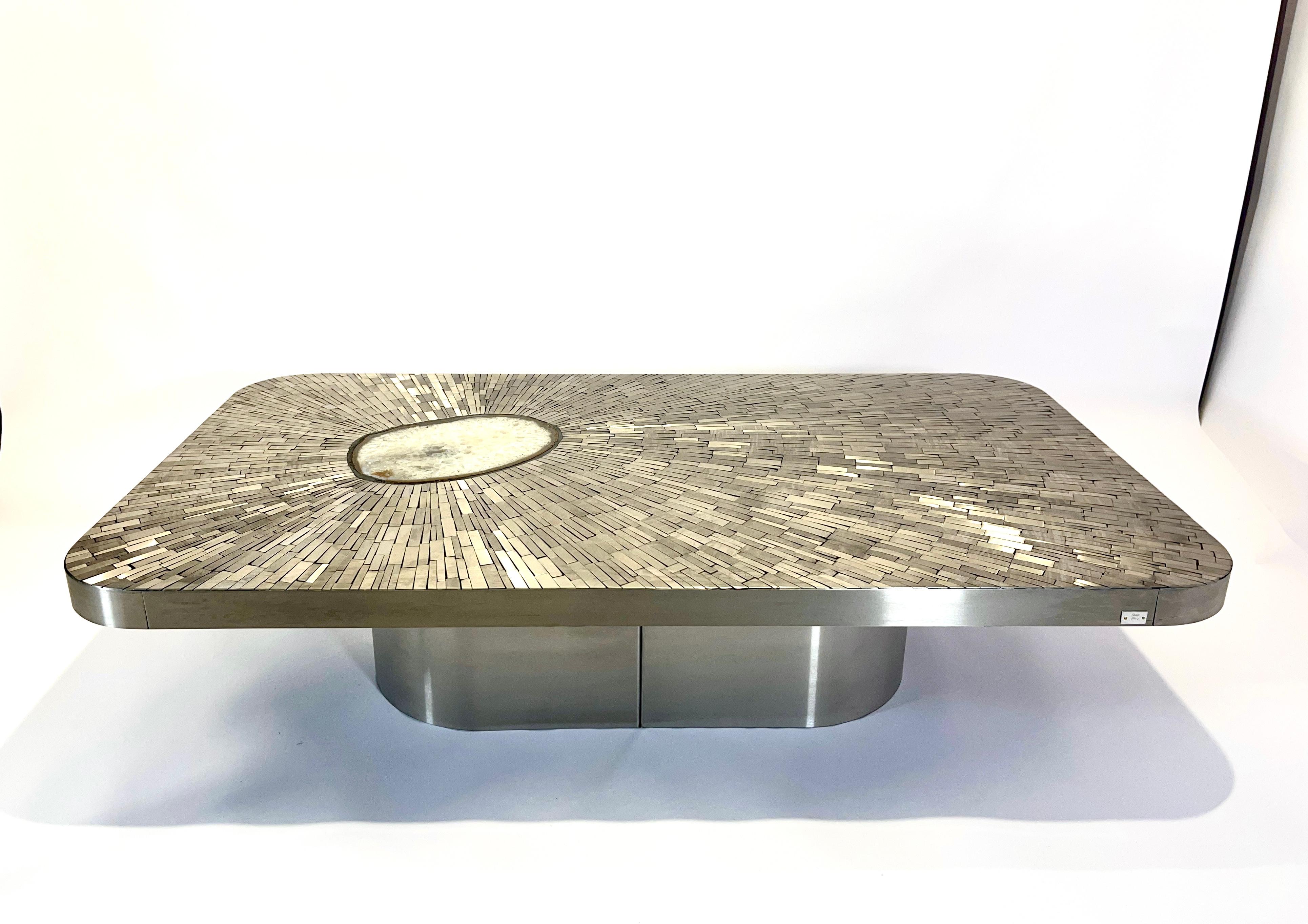 Created to measure by Stan Usel, this coffee table of stainless steel, table topped with a magnificent mosaic stainless steel agate gemstone highlighting a mosaic radiation. Each piece is topped with a unique stone and when put together aside gives