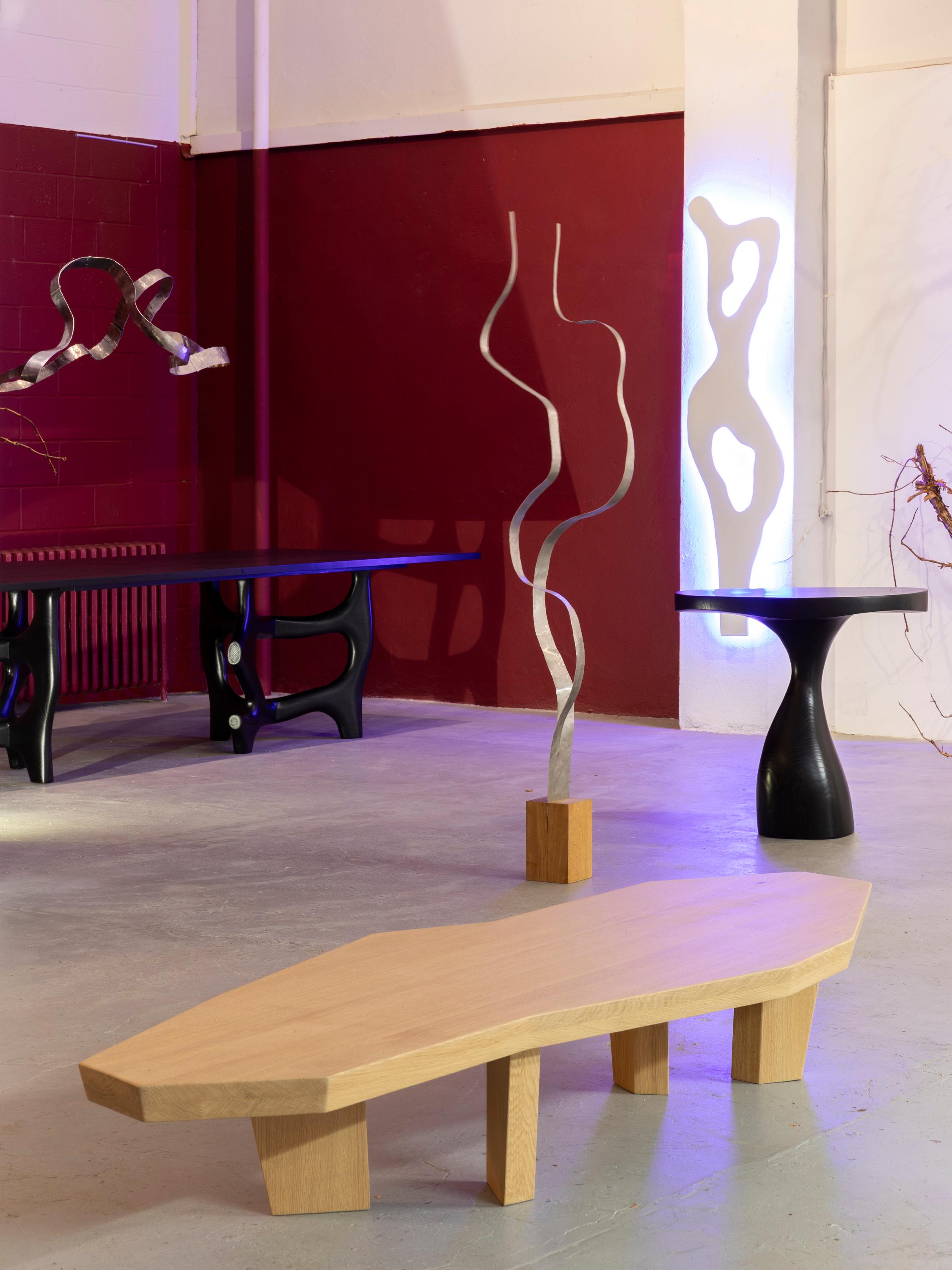 This long, faceted coffee table by Jacques Jarrige is hand-sculpted in natural oak, its edges cut and carved with characteristic intuition and rhythm. More than a piece of furniture, it is a functional sculpture—defined by subtle asymmetries and a