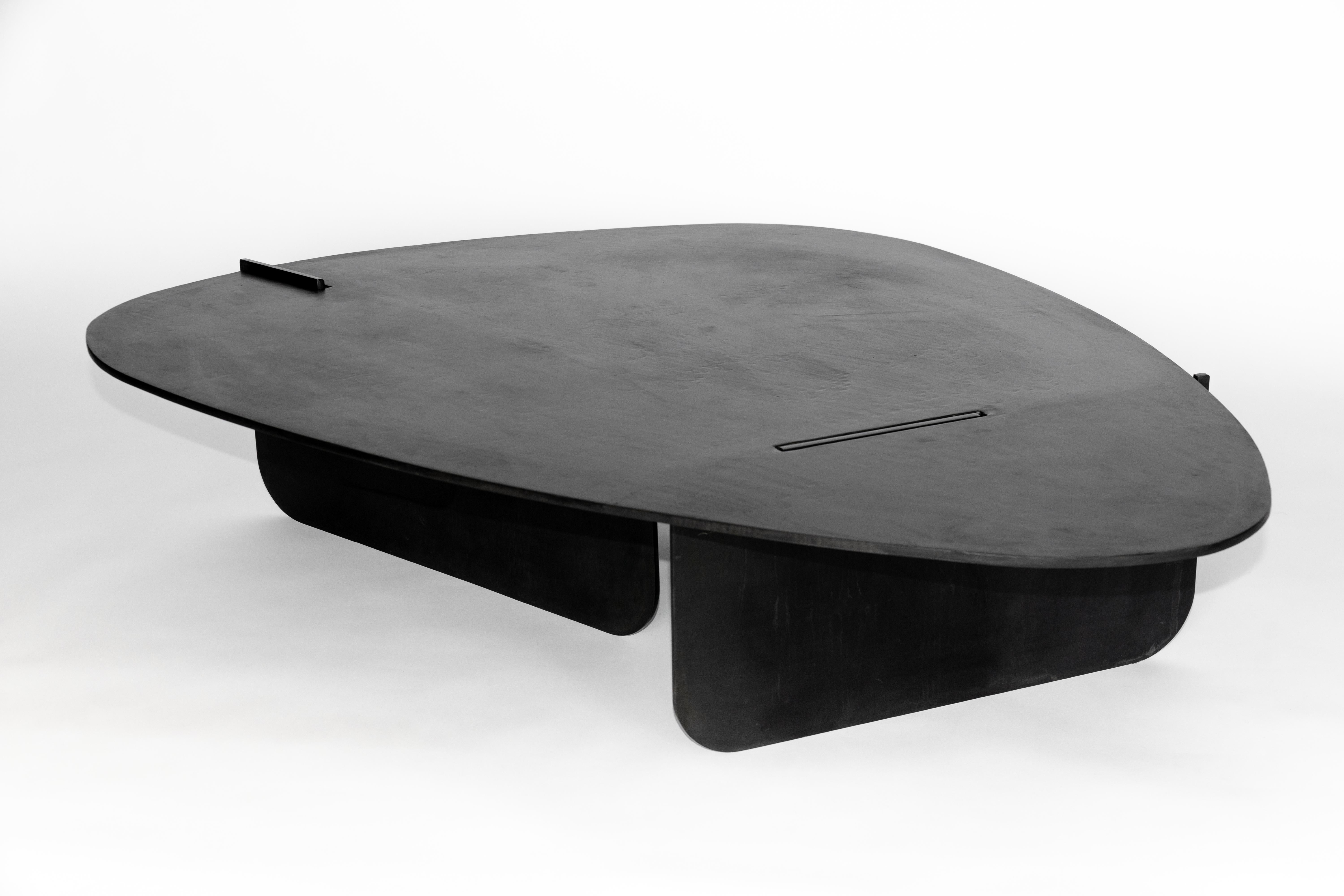 Coffee table No. 15 by JM Szymanski
Dimensions: L 52” x W 36” x H 13” 
Materials: Blackened waxed steel

Jake Szymanski lives and designs in New York city.
His design education began in his early childhood where he grew up in Nepal. He studied