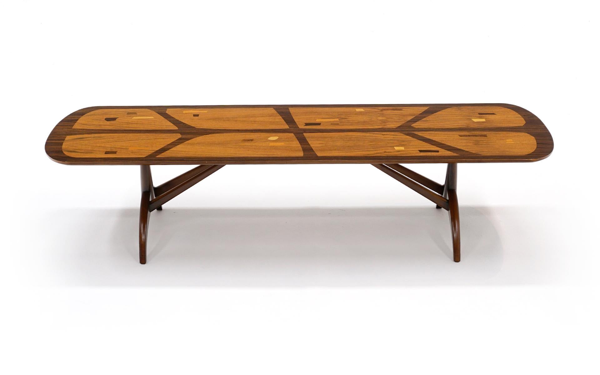 Coffee table with beautiful inlayed designs, likely from Brazil. Rosewood, walnut and mahogany. Rectangular form with rounded corners. Quite possibly one of a kind.
