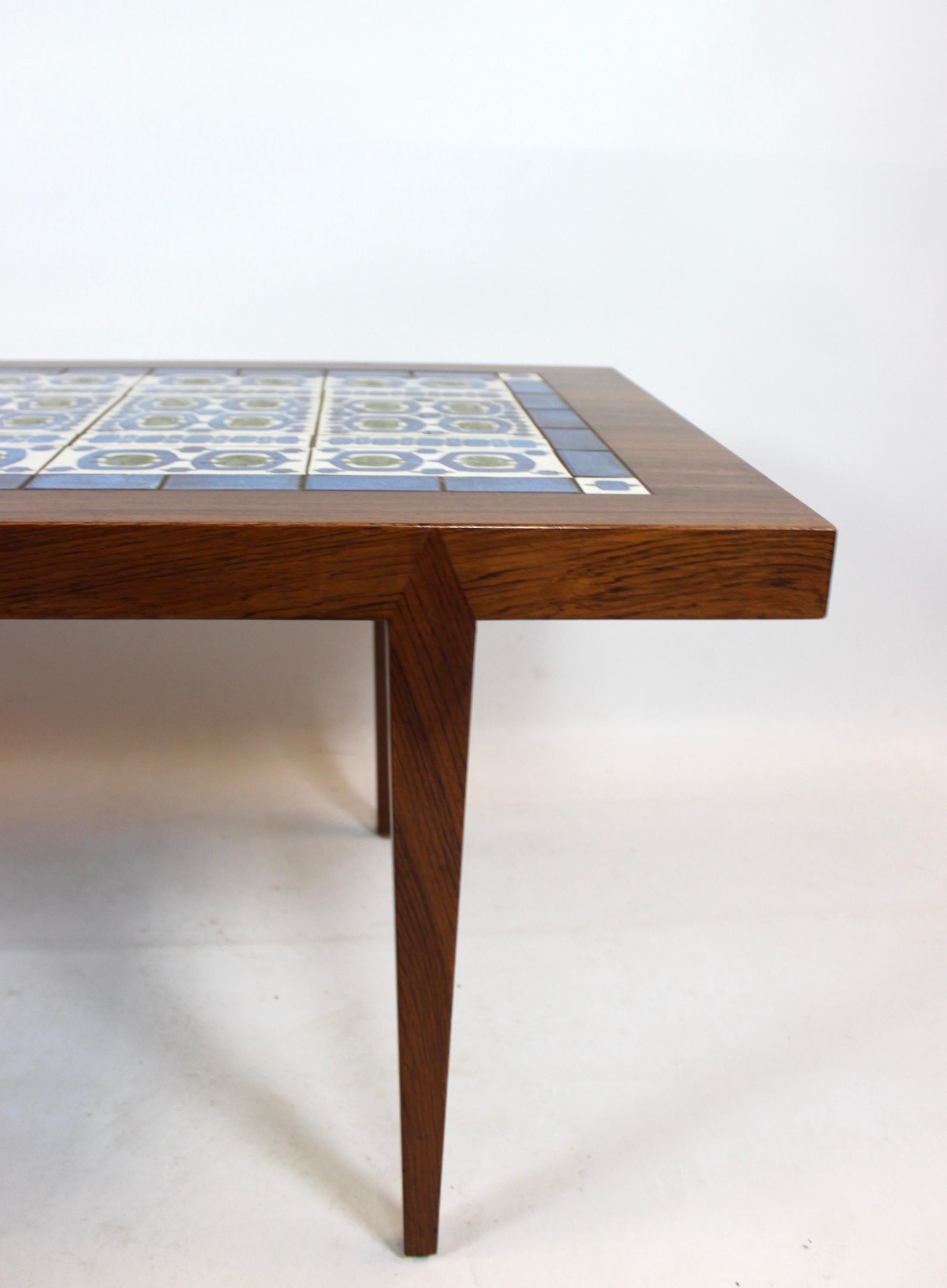 Coffee table of rosewood and dark blue tiles from Royal Copenhagen, designed by Severin Hansen for Haslev Furniture Factory from the 1960s. The table is in great vintage condition.
 