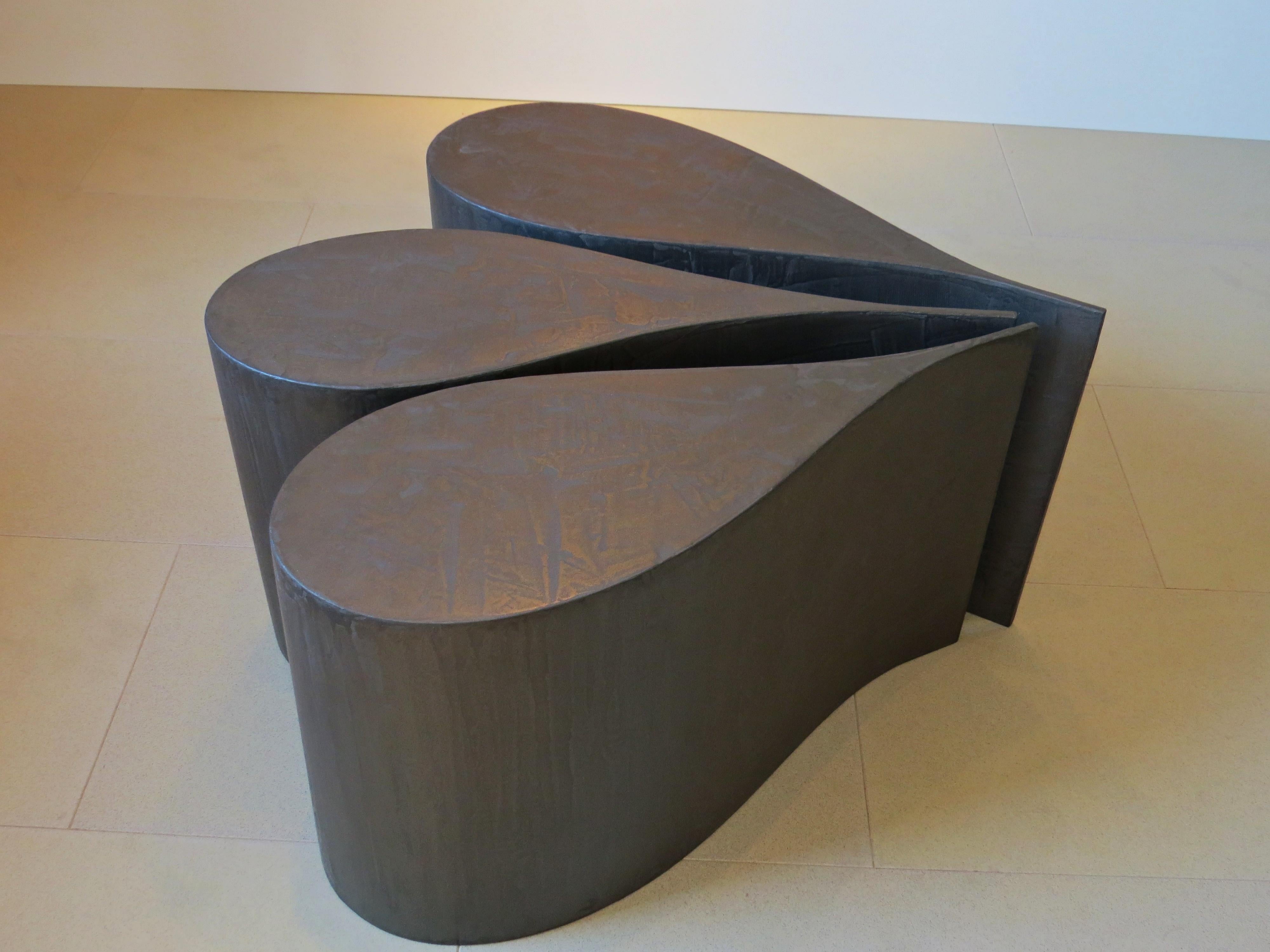 Three set in drop form, as a coffee table or side table.

What looks very heavy here is actually extremely light: one part weighs only 2.4 kg, so it is very flexible.
Plywood is glued in shape and then coated with titanium.

Also available in