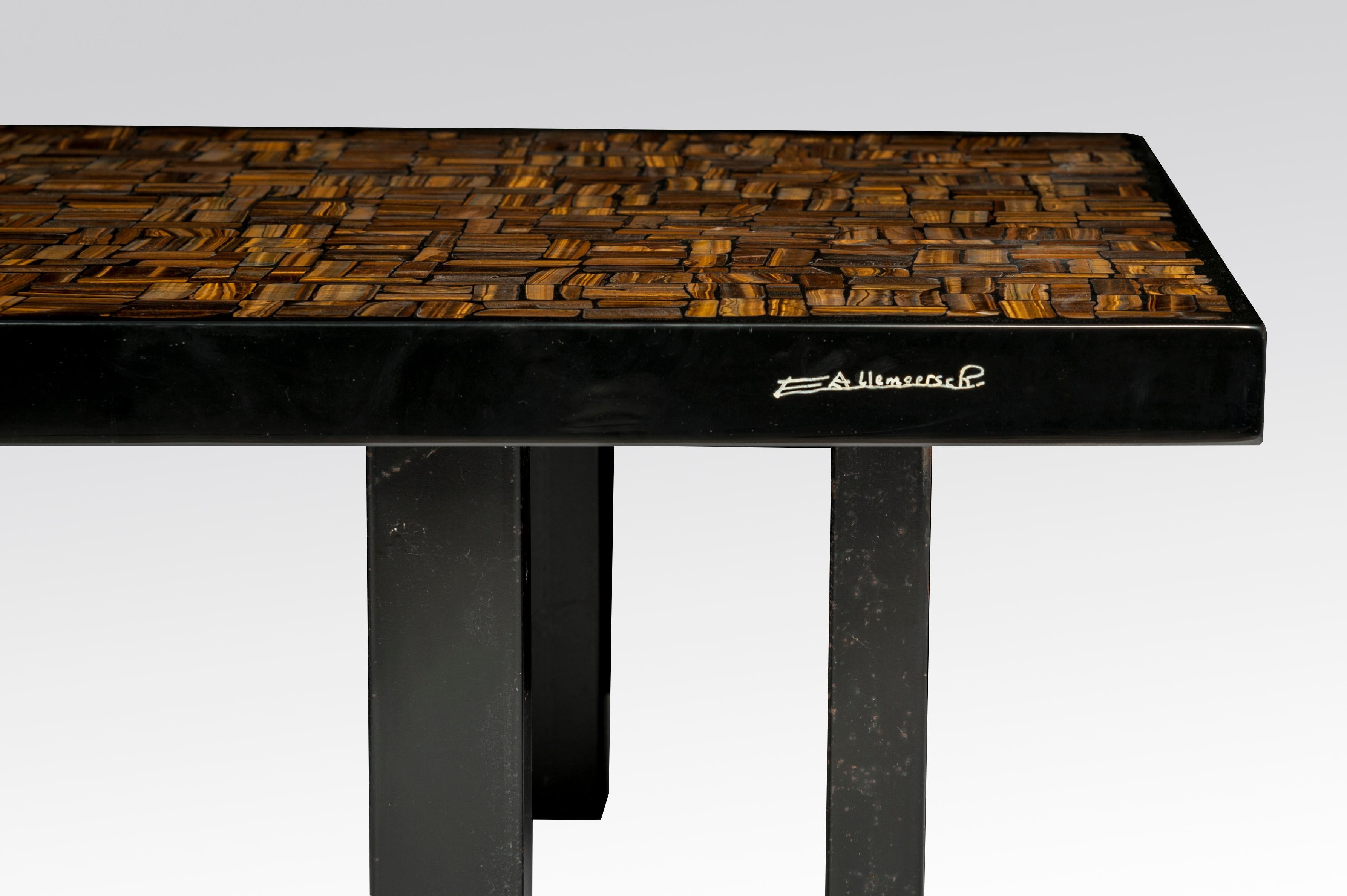 This coffee table by Etienne Allemeersch, an artisan who worked in the workshop of Ado Chale, is executed rectangular coffee table in resin with an inlay of tiger eye wood. The piece sits on a steel base and was produced in Belgium during the