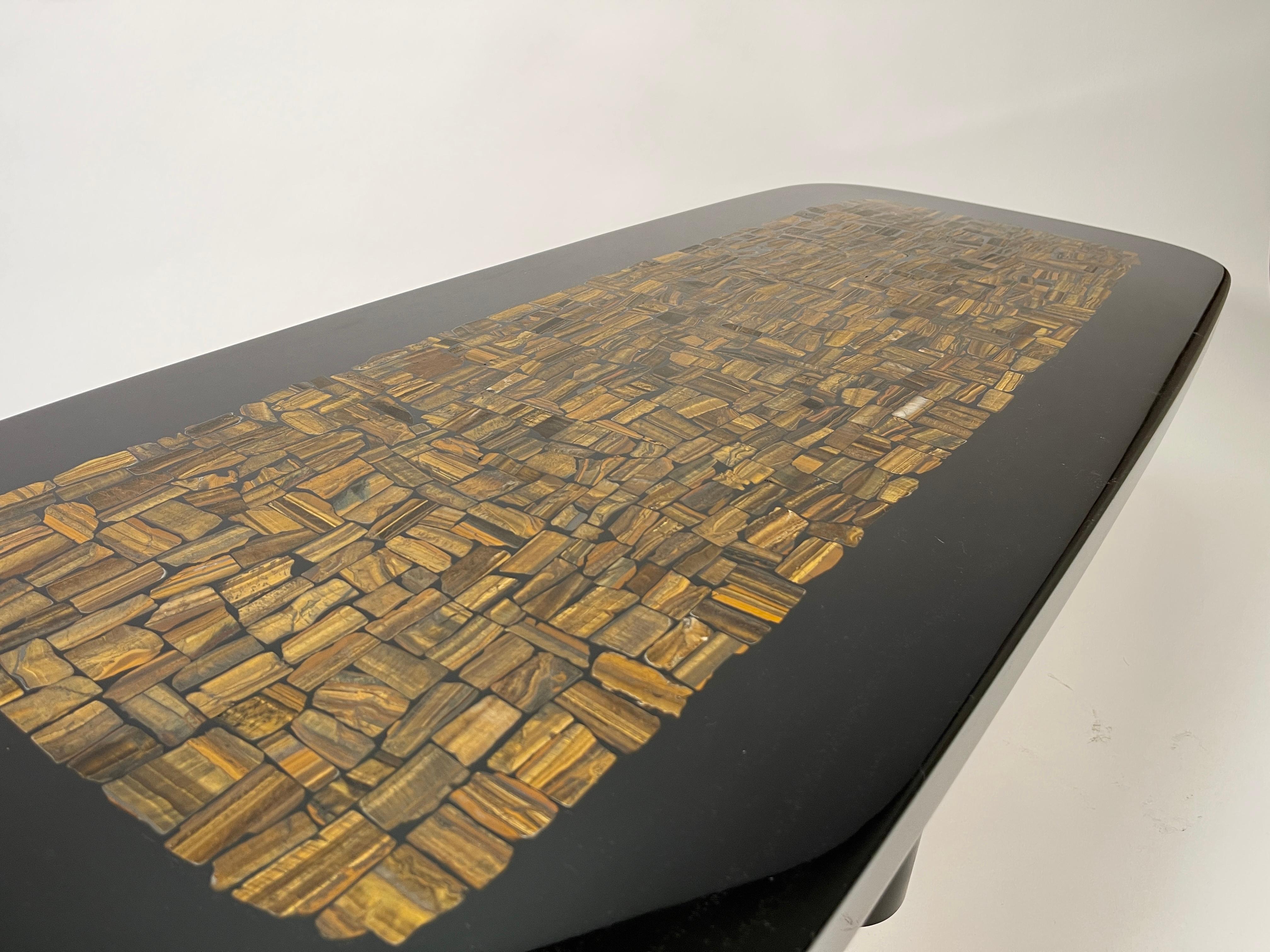 This coffee table by Etienne Allemeersch, an artisan who worked in the workshop of Ado Chale, is executed rectangular coffee table in resin with an inlay of tiger eyes. The piece sits on a steel base and was produced in Belgium during the