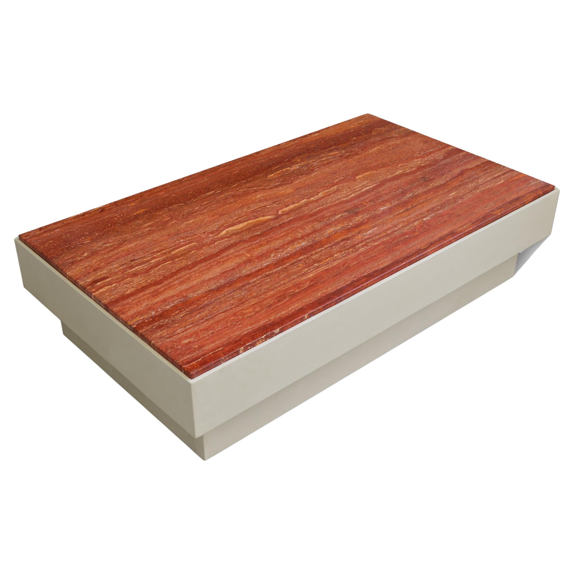 This coffee table has been manufactured with a Red Travertine Top, with a glossy finishing . The base in ivory lacquered wood with geometrical shape 
Size: cm. 132 x 77 h. 32
Inches: 51.97