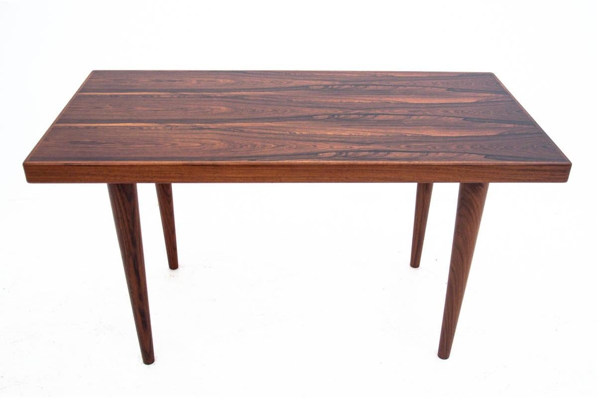 Coffee table made in Scandinavia in the 1960s.

The furniture is made of rosewood with rich grain. The table has slender, tapering legs that give the whole thing lightness and elegance. The table has been renovated. The wood has been cleaned and