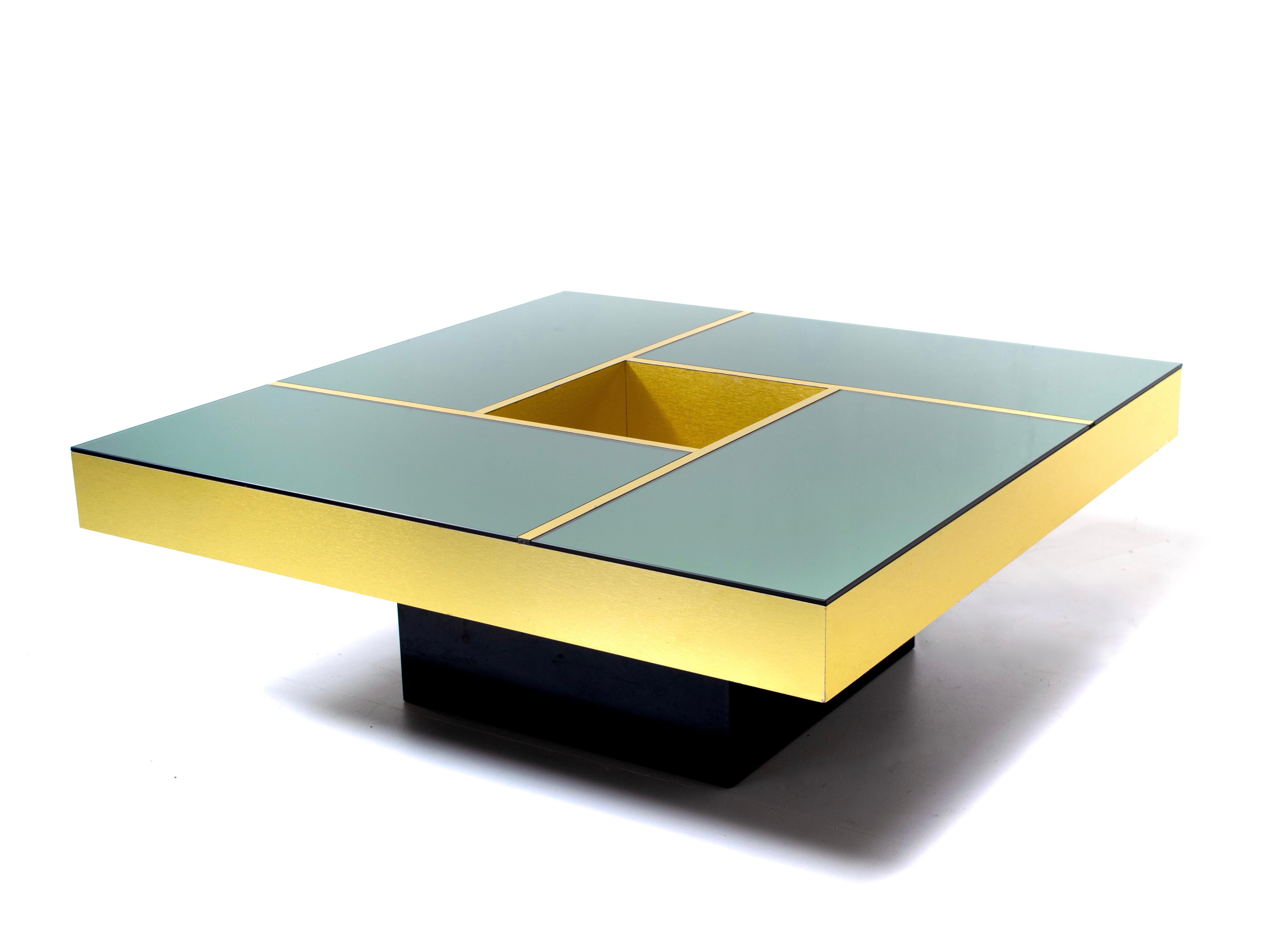 Coffee table 'Shilling' designed by Giovanni Ausenda, Guido Baldo Grossi & Gianni Gavioli for NY Form of Bologna in the 1970s. Amazing gold colored table with a smoked mirror top that is divided into four sections divided by gold bands. This table