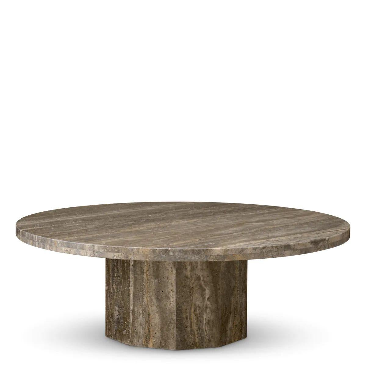 The Coffee Table is a sculptural coffee table crafted from silver travertine stone. This elegant table features a low profile and a bold base inspired by Romanesque architecture, specifically a 12th-century Catalan column shaft. The silver