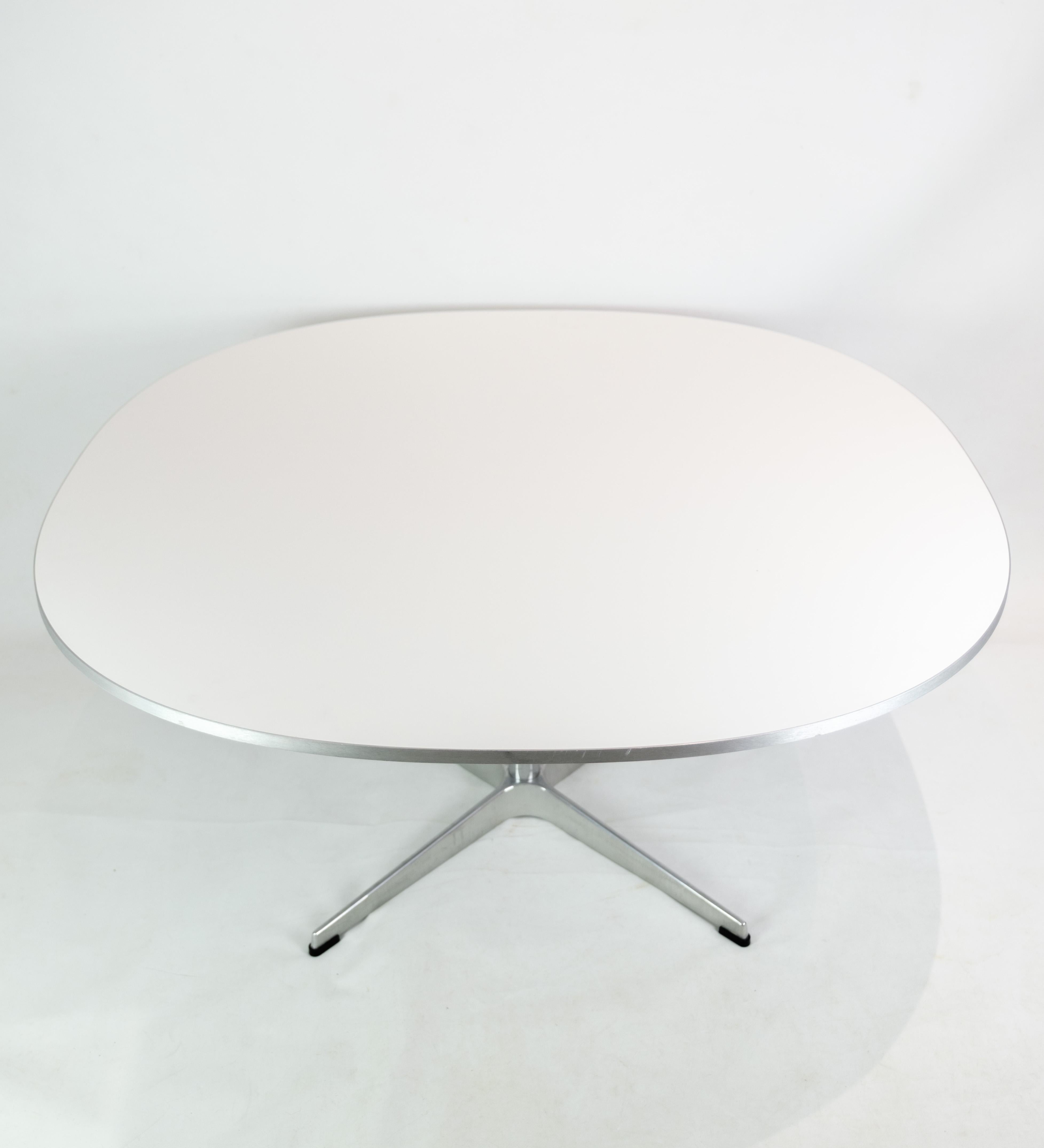 Coffee table, designed by Piet Hein/Bruno Mathsson/Arne Jacobsen and produced by Fritz Hansen in 2018. The table has white laminate with aluminum silver edge, and aluminum frame. Stamped with original brand and production number.