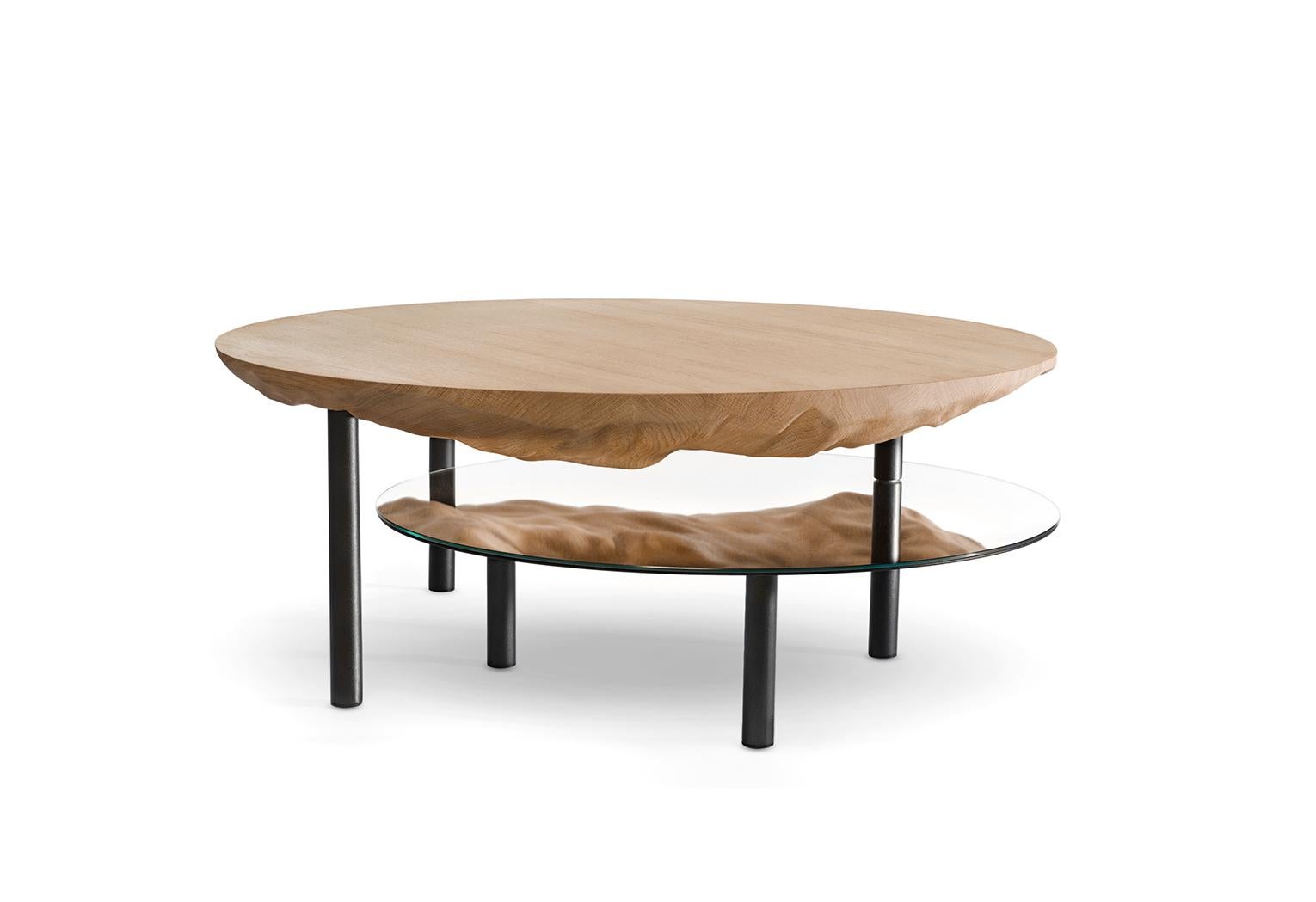 Solco is a coffee table that hides its game well. The purity of the object hides a sculptural surprise. 
Compounded of two tops, this solid oak table reveals its hidden side thanks to the mirror pivoting along a central leg. 
The gouged side