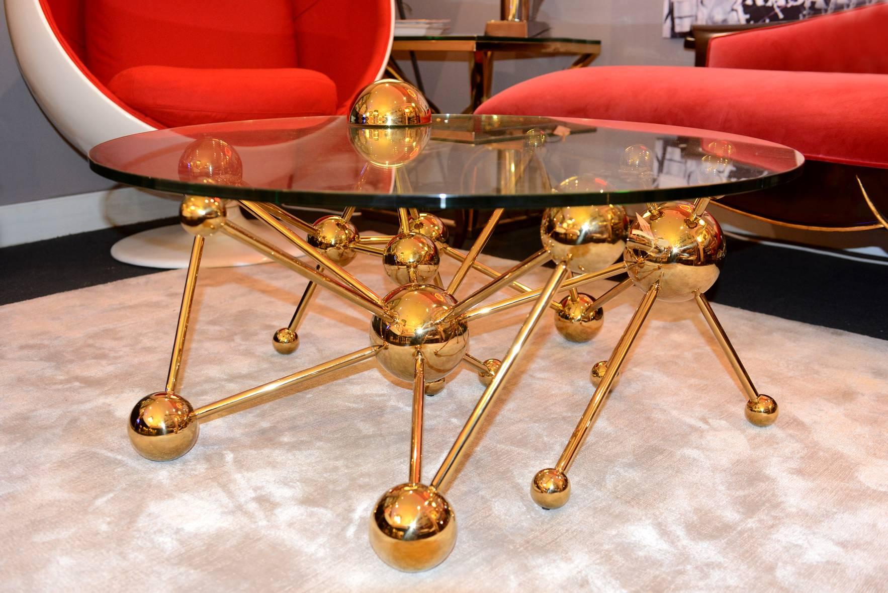 Coffee table with stainless steel gold 
finish structure and with clear glass top.
 