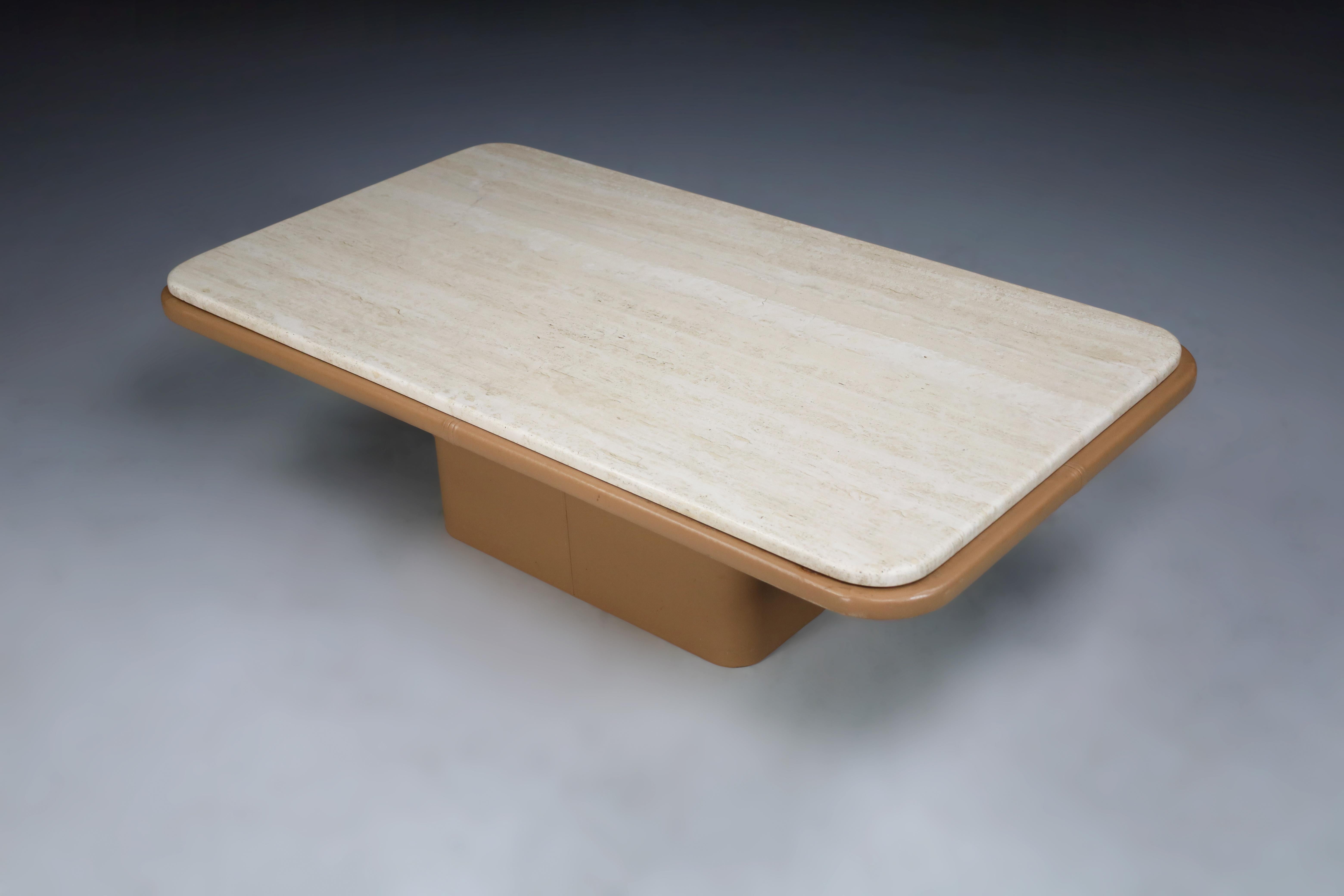 De Sede, coffee table, strong travertine top, leather, Switzerland, the 1970s. This exquisite coffee table is beautifully designed, featuring an excellent structure of sharp lines and geometric shapes. The construction has a unified appearance as