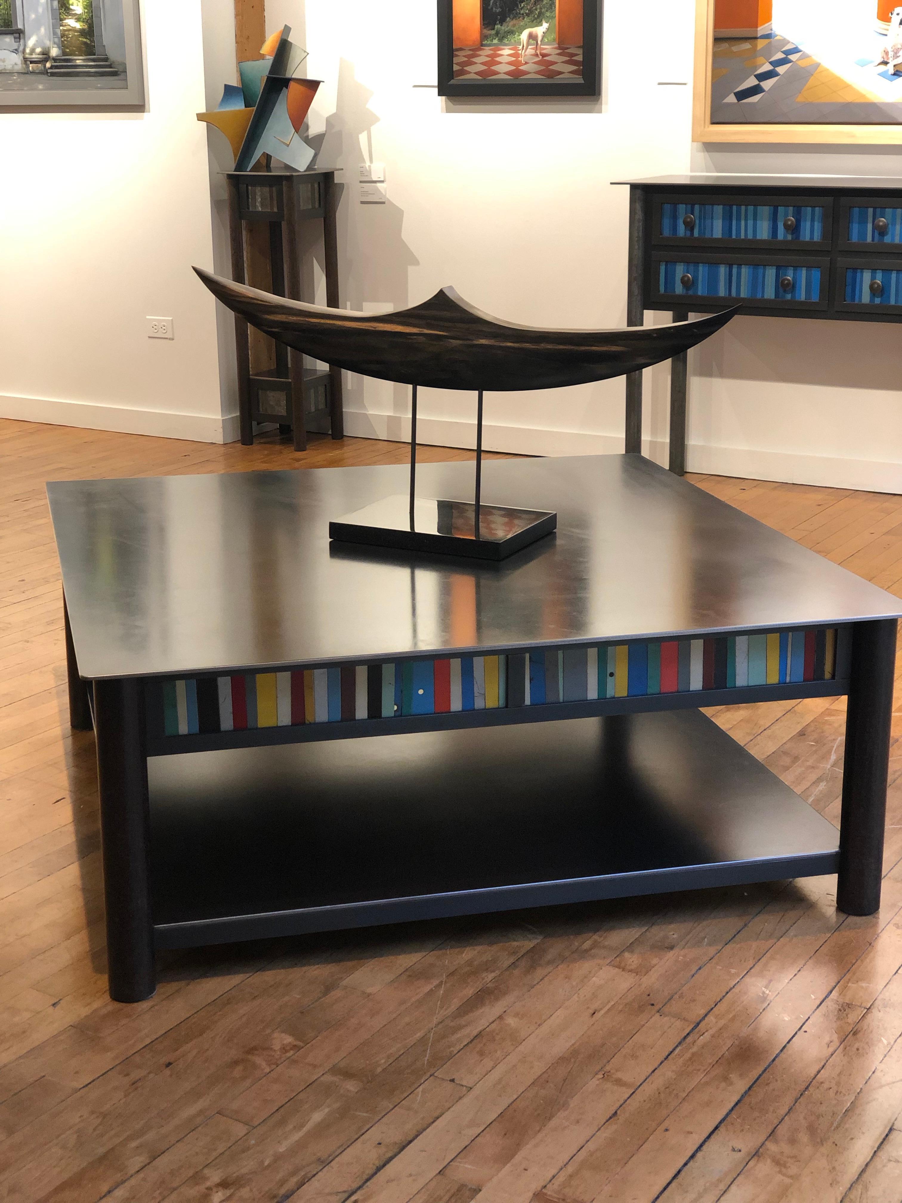 This is a welded steel modern industrial coffee table with a low shelf and a quilted skirt of found metal strips arranged in a quilt pattern inspired by the quilts of Gee's Bend Alabama. Each piece of furniture is unique and made by Jim Rose. The