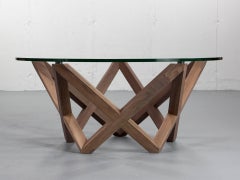 COFFEE TABLE with a black walnut star shaped base and round glass top