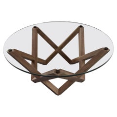 COFFEE TABLE with a black walnut star shaped base and round glass top