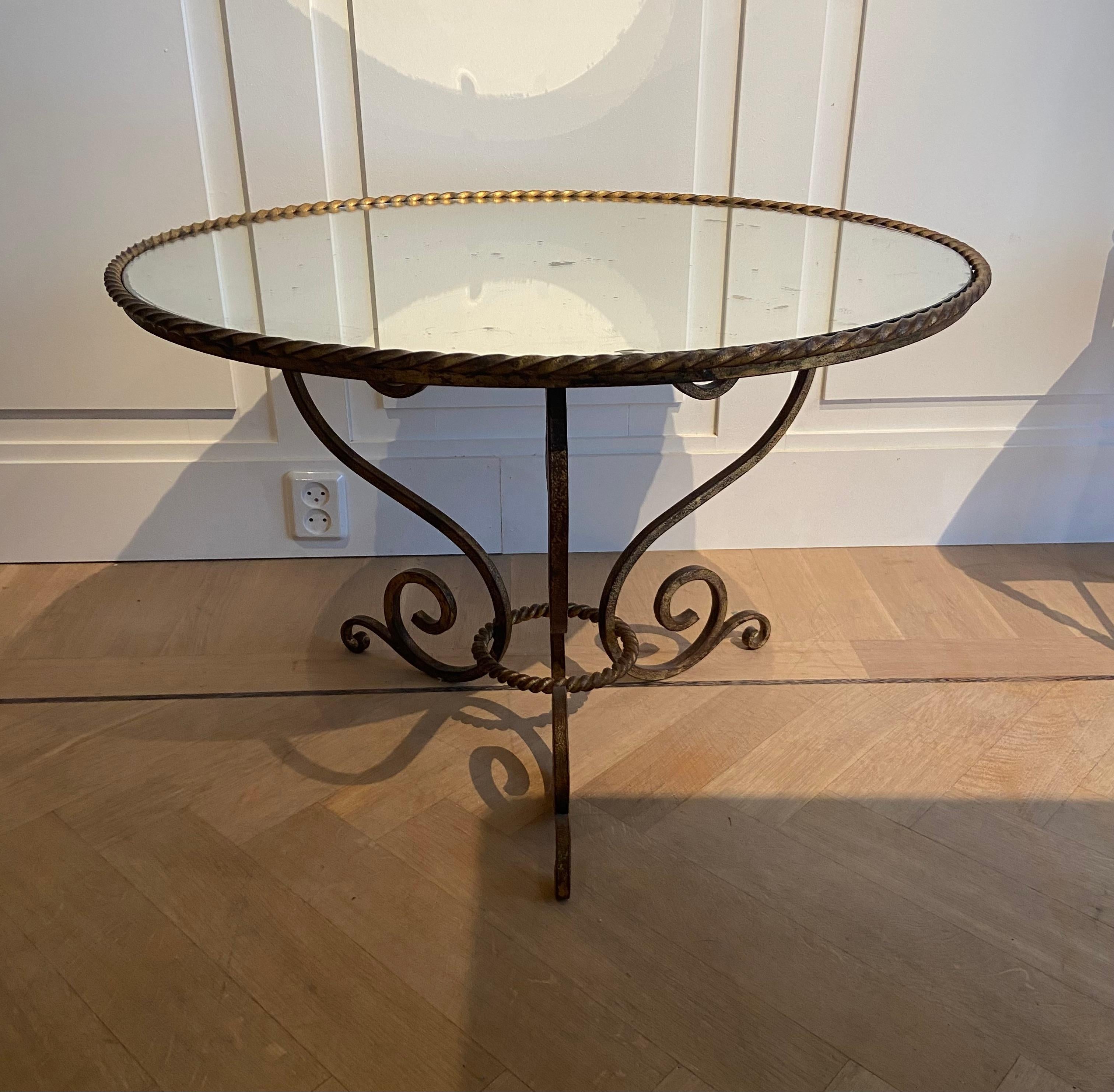 Coffee table with a mirror top. The frame is made of forged iron.
France, circa 1940