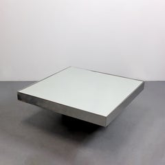 Coffee table with a smoked glass cross base and mirrored top