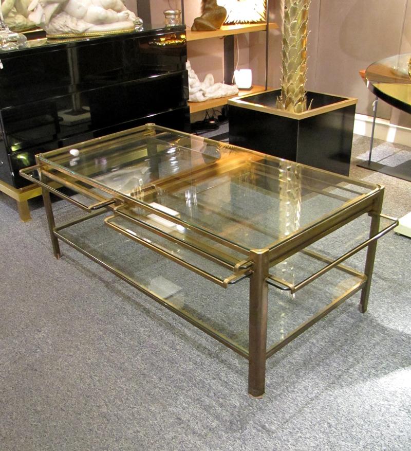 Jacques Quinet, France, (1918-1992)
Rare coffee table with four sliding pulls, in polished bronze supporting glass shelves.
Signed and numbered.

Maximum open dimension:
Length 61 in
Width 41 in
Height 15.35 in

In 1937, Jacques Quinet was