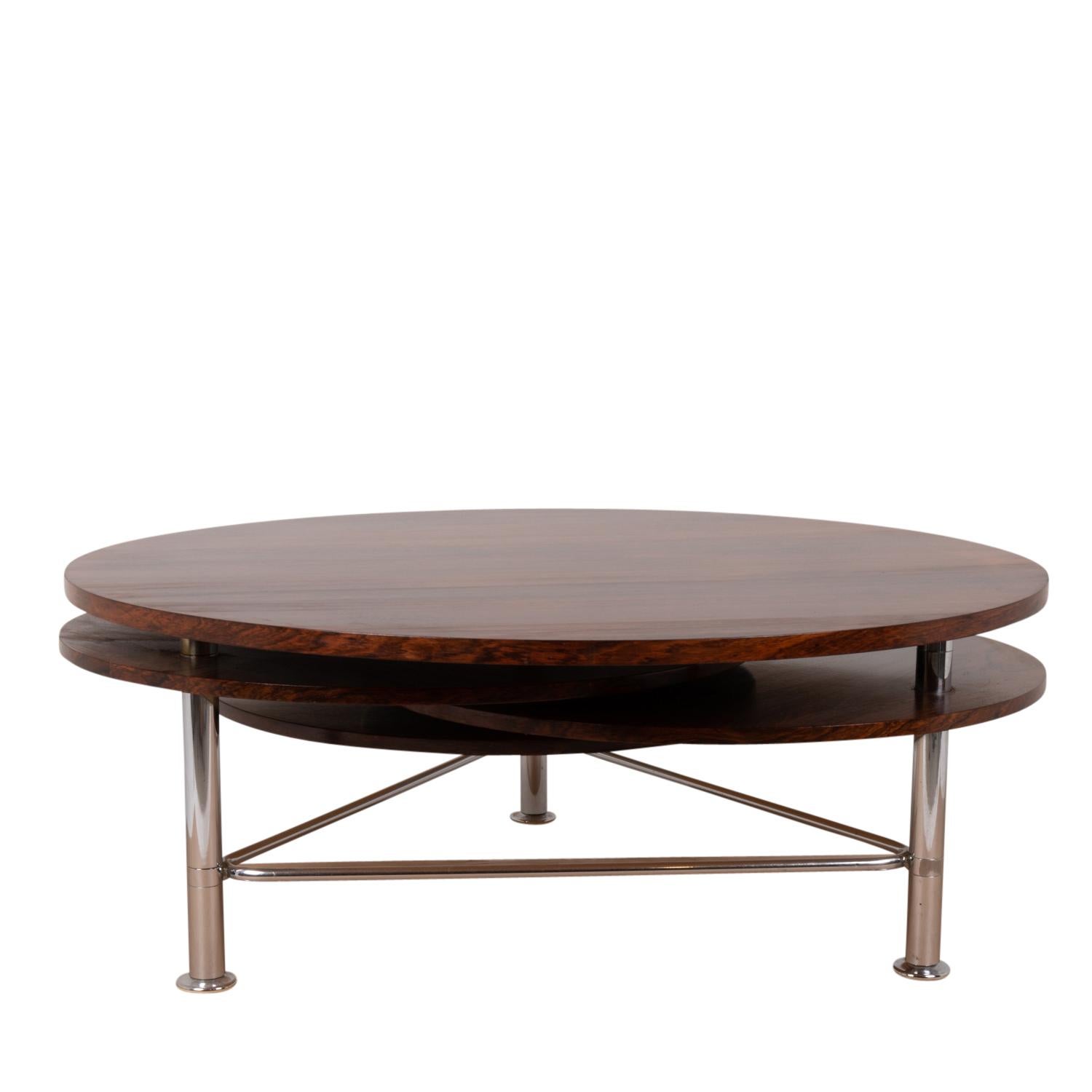 Coffee table in rosewood, consisting of four circular pivoting trays. Base in chromed metal.

Dutch work realized in the 1970s.

Dimensions: H 43 x D minimum 110 / maximum 220 cm.