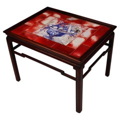Chinese inspired mahogany coffee table with tiles in red, white and blue nuances